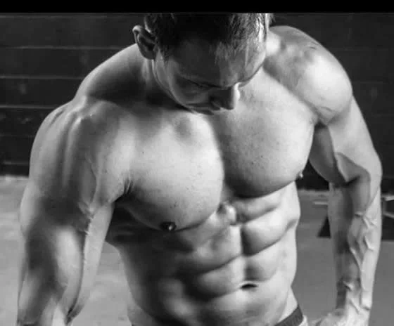 Man without shirt flexing