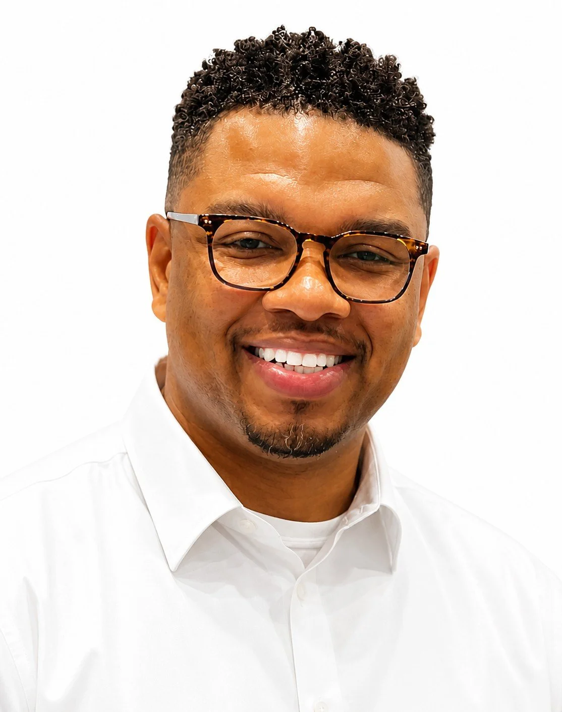 Smiling man with glasses wearing a white button-up shirt