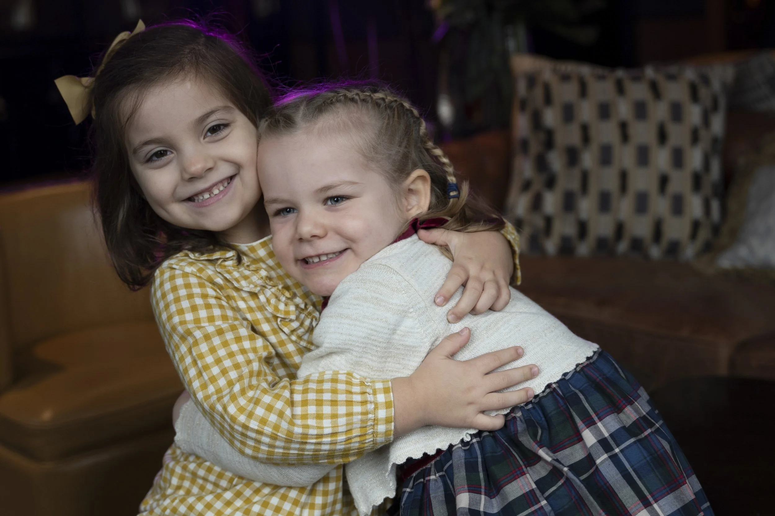 Two young girls hugging and smiling