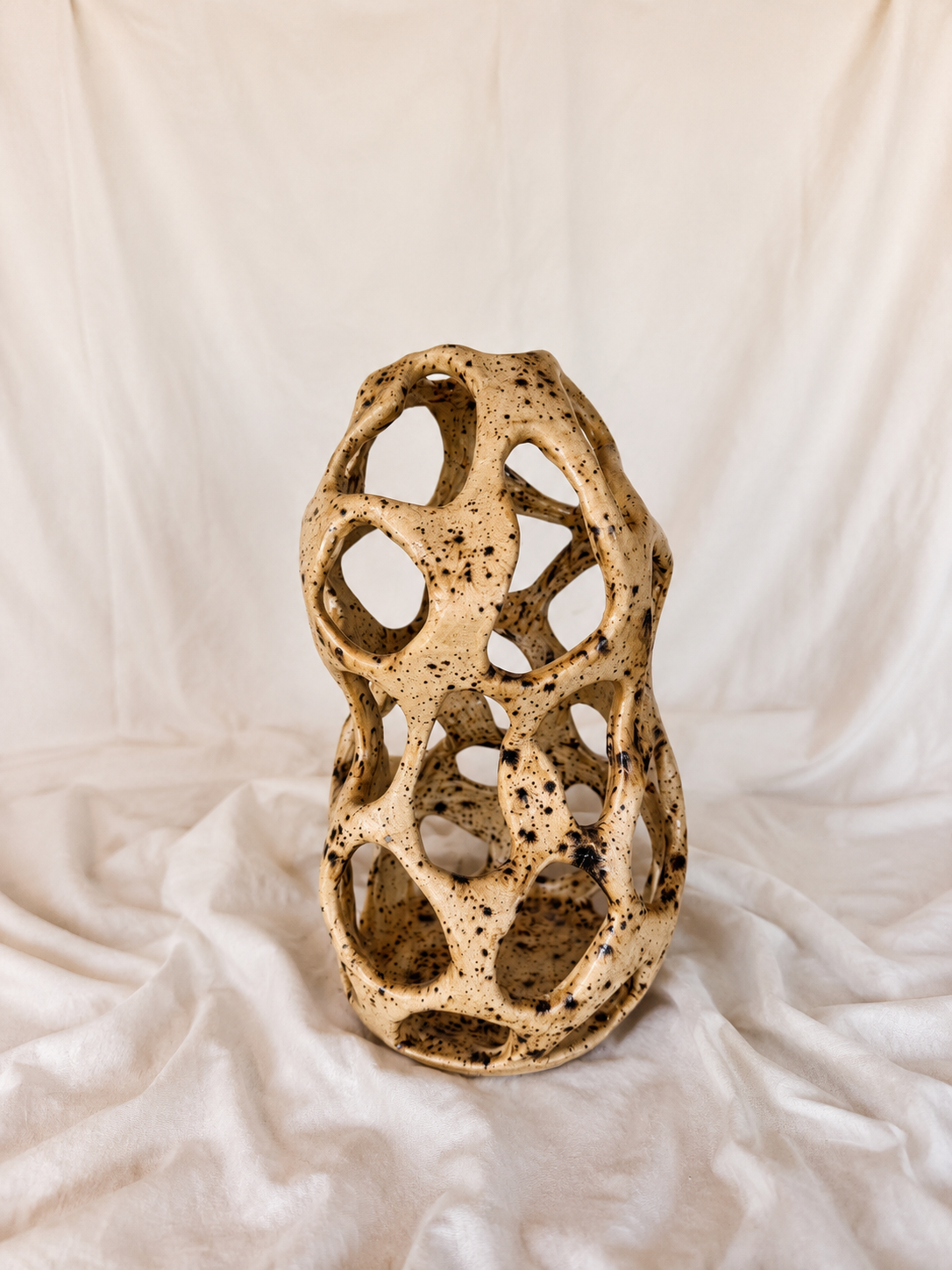 speckled vase with holes