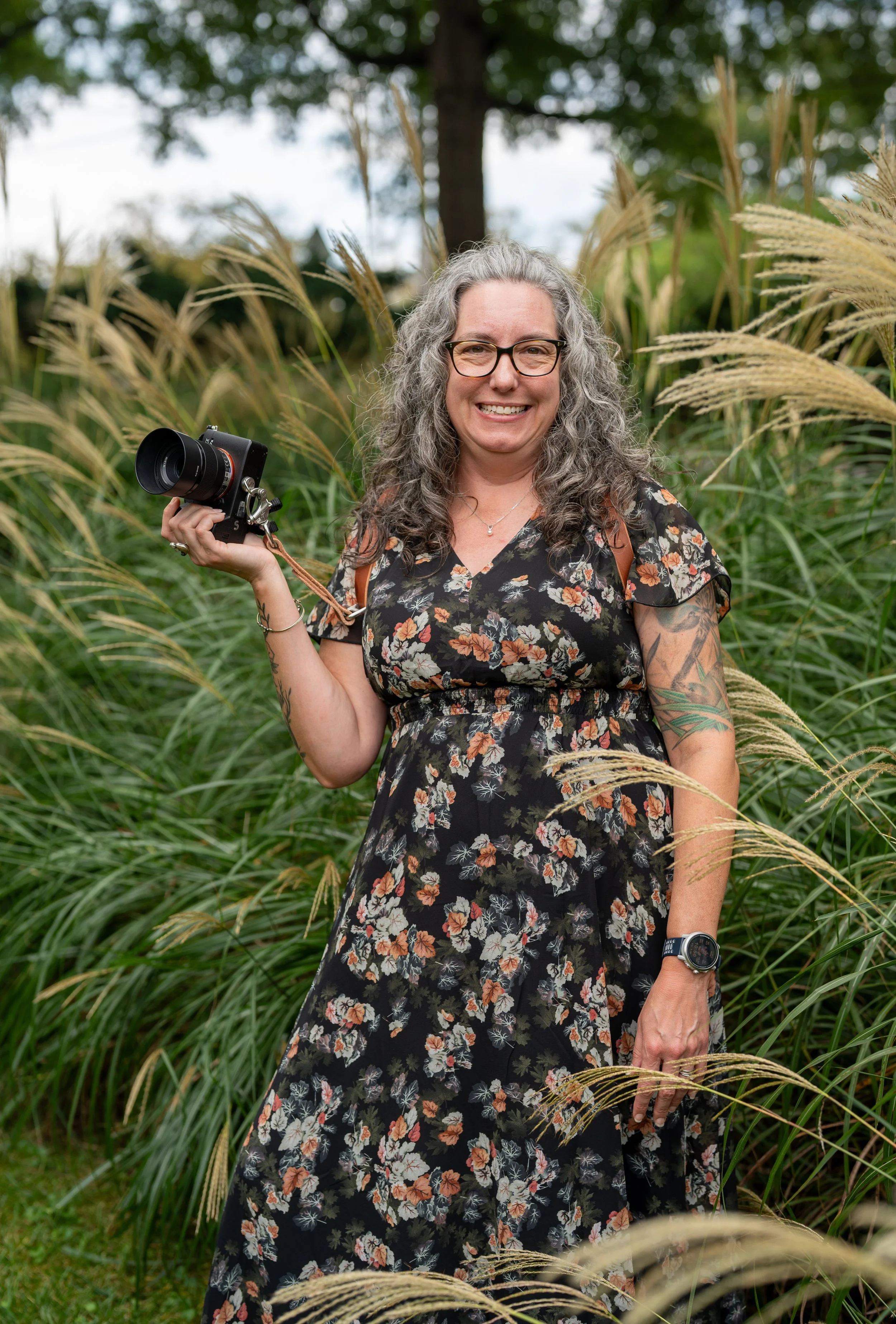 Portrait of Carole Gabrielson holding her camera