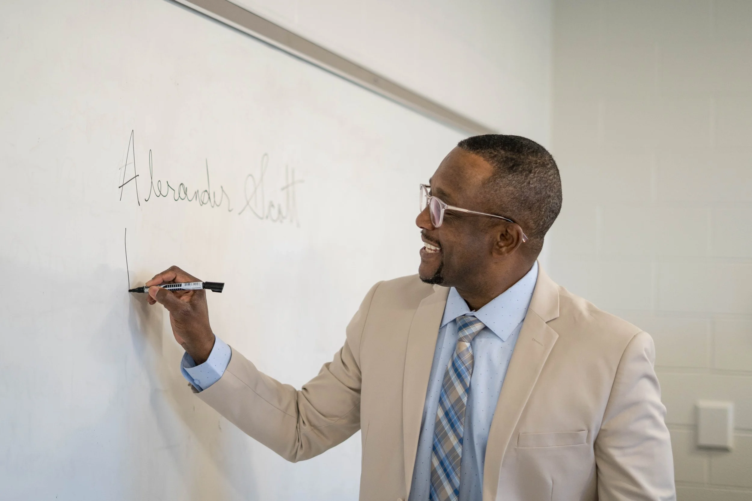 Instructor writing on a whiteboard