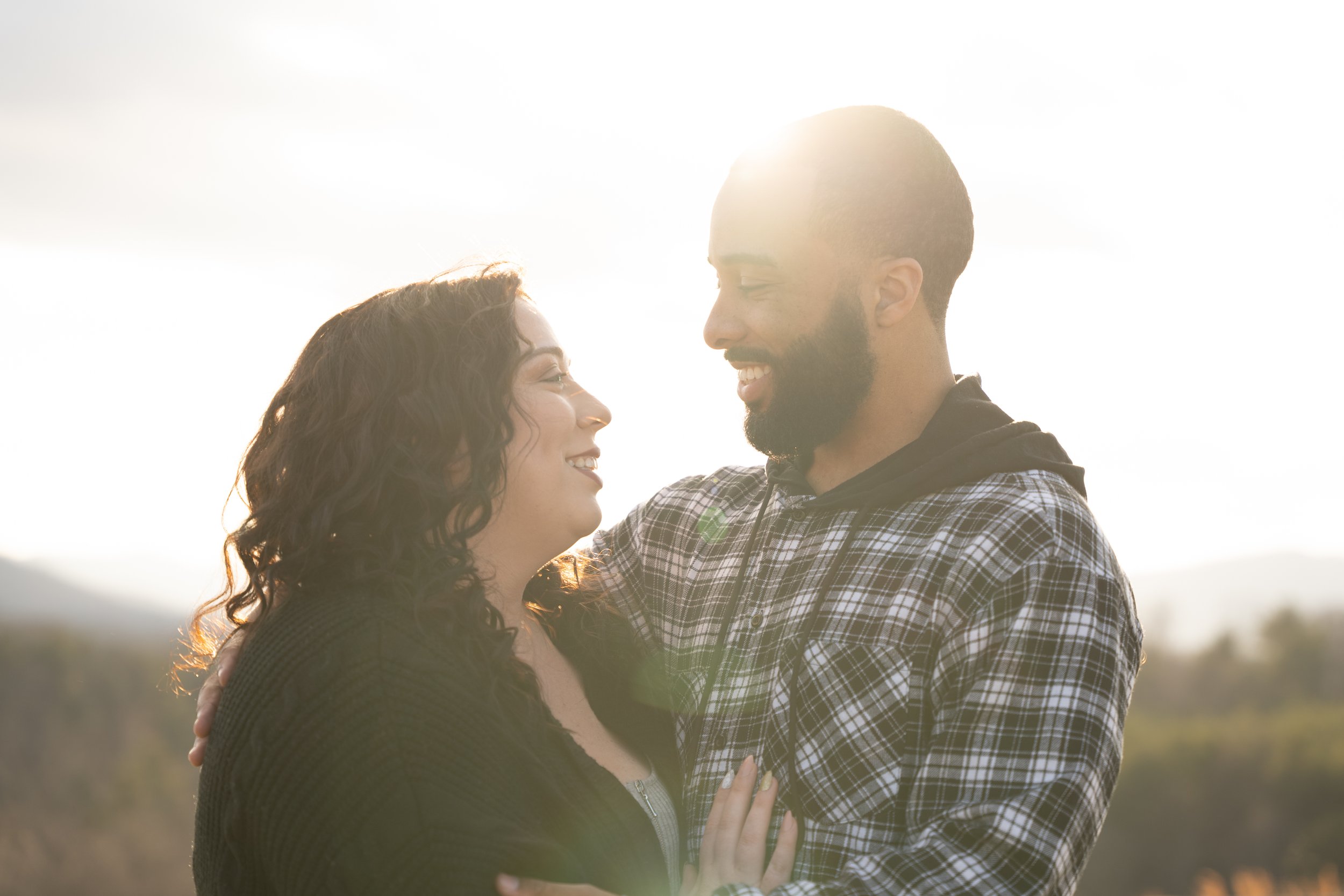 Man and woman with their arms around each other and smiling