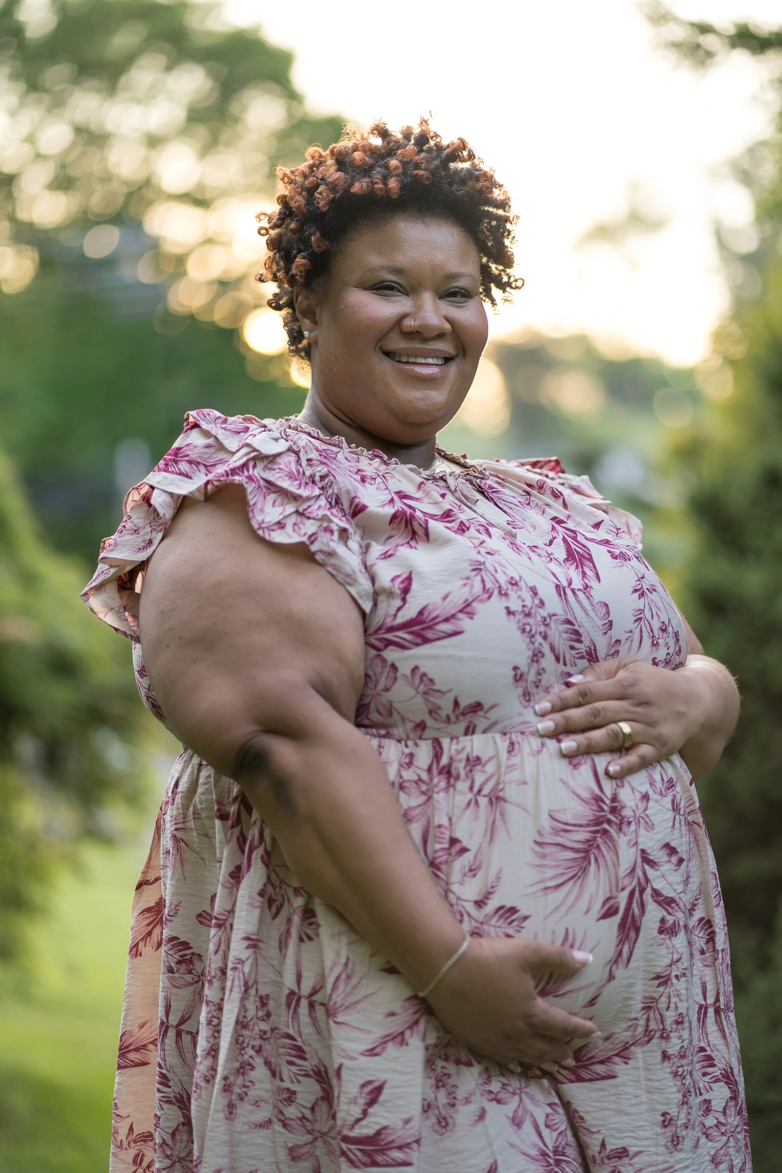 Jamie Dillard posing during her maternity shoot at Virginia Western Community College's arboretum.