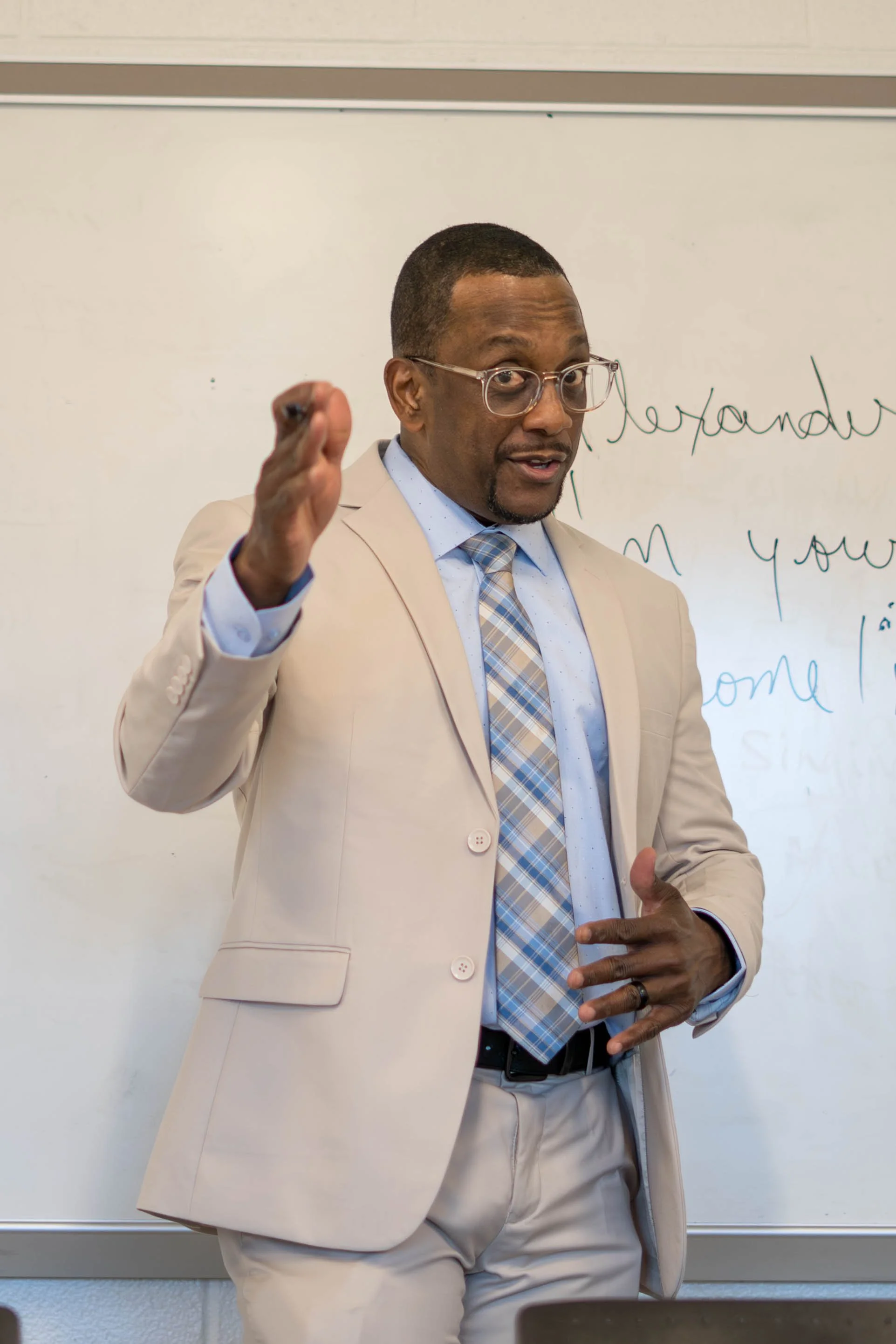 Instructor lecturing in front of a whiteboard