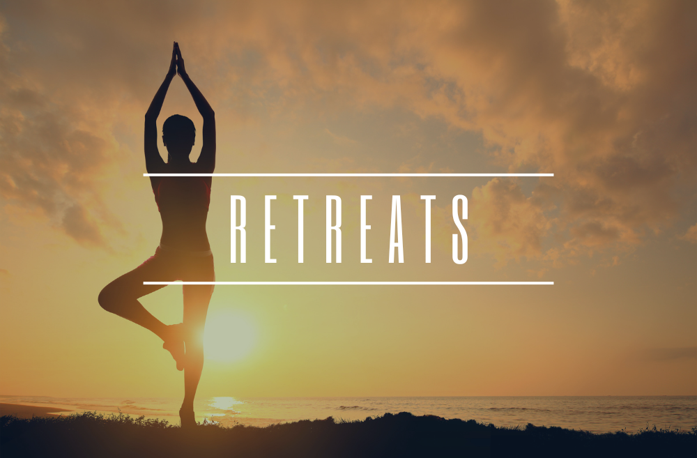 Silhouette of a person practicing yoga in a tree pose on the beach during sunset or sunrise with the word "RETREATS" overlaid.