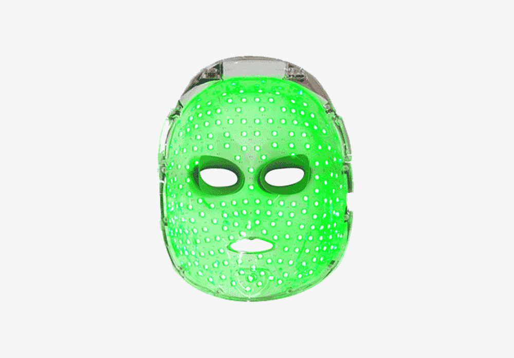 Green LED mask with holes, resembling a stylized human face, on a white background.