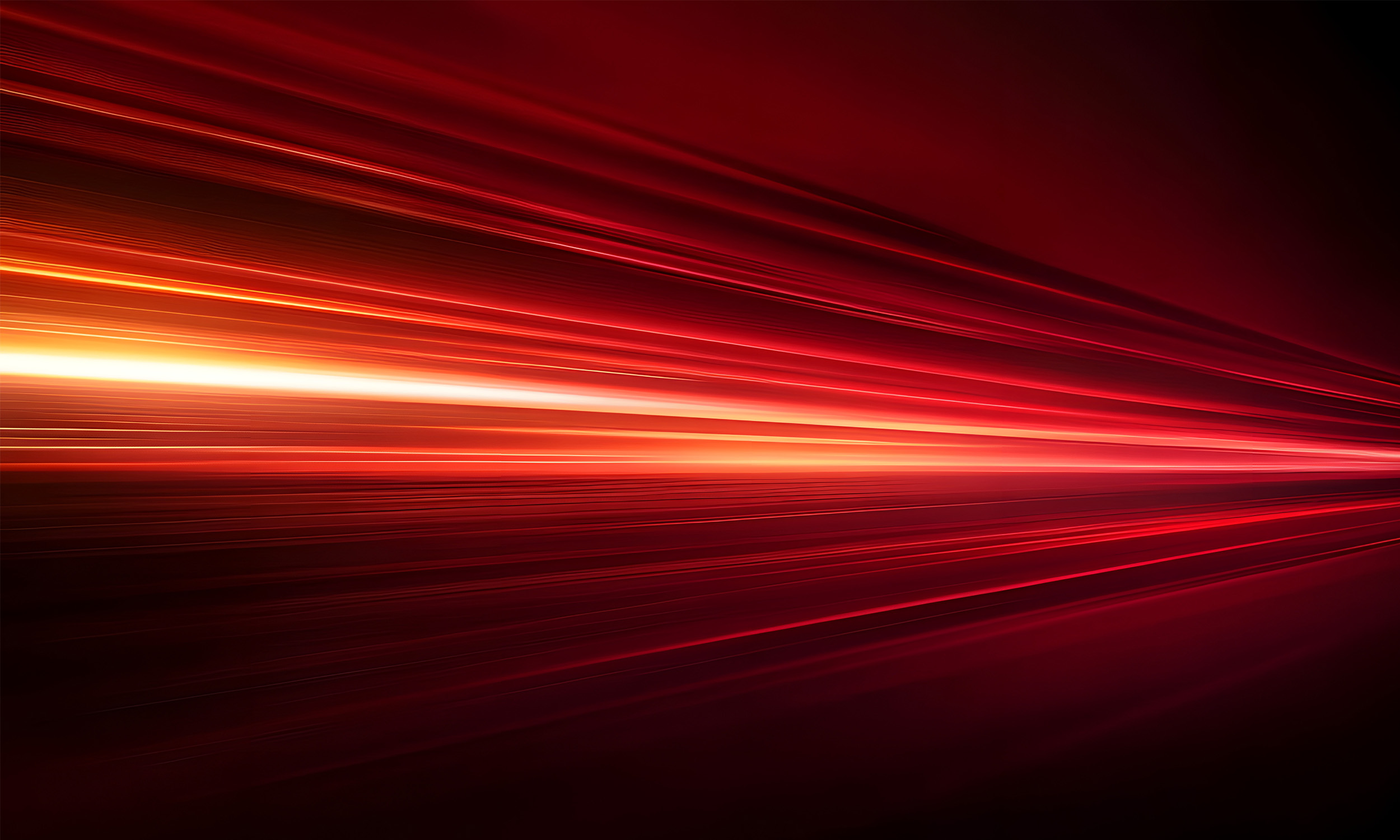 Bright red and yellow streaks of light moving across a dark background, creating a dynamic and abstract image.