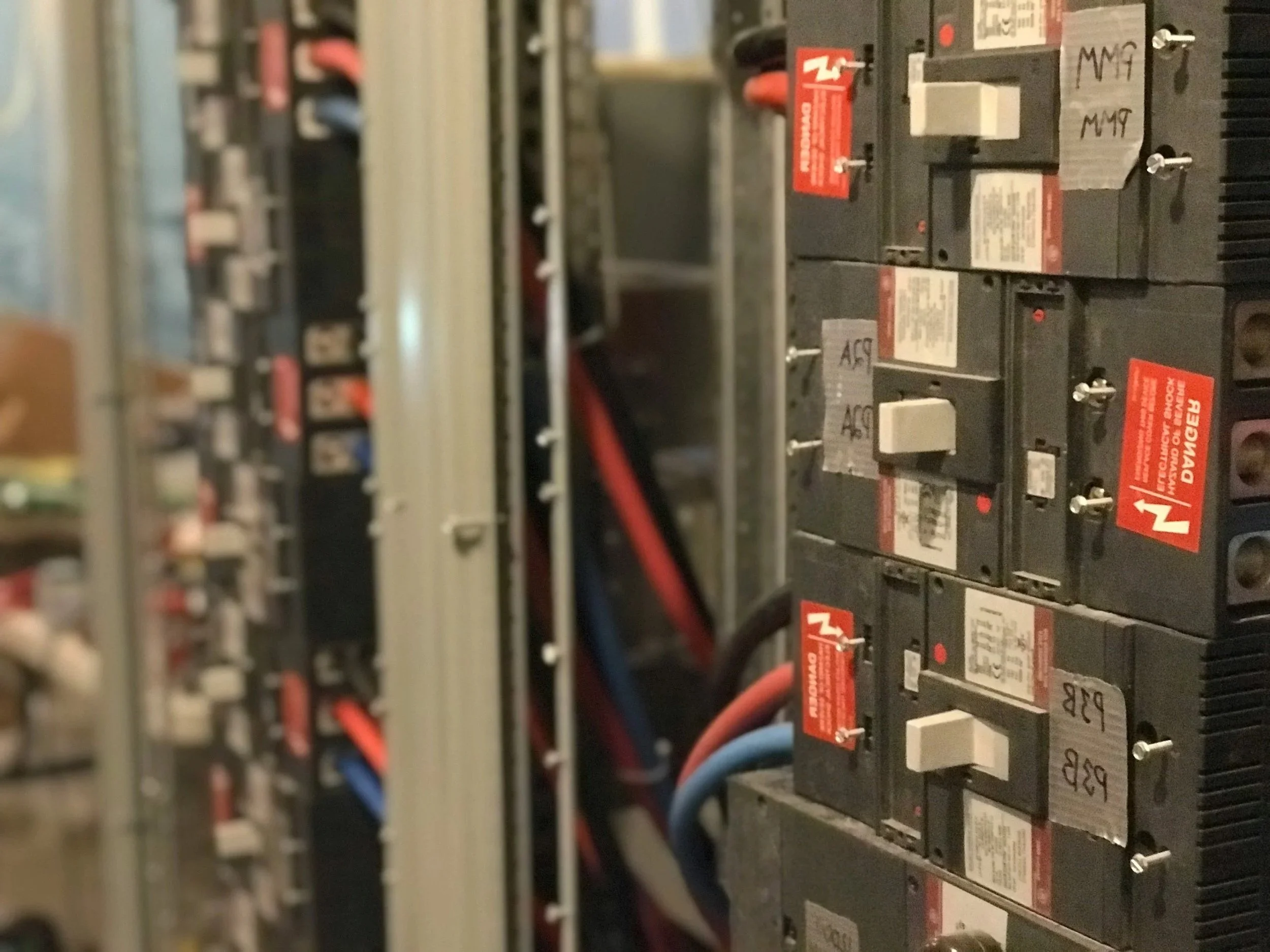 Close-up of an electrical control panel with circuit breakers and wiring.