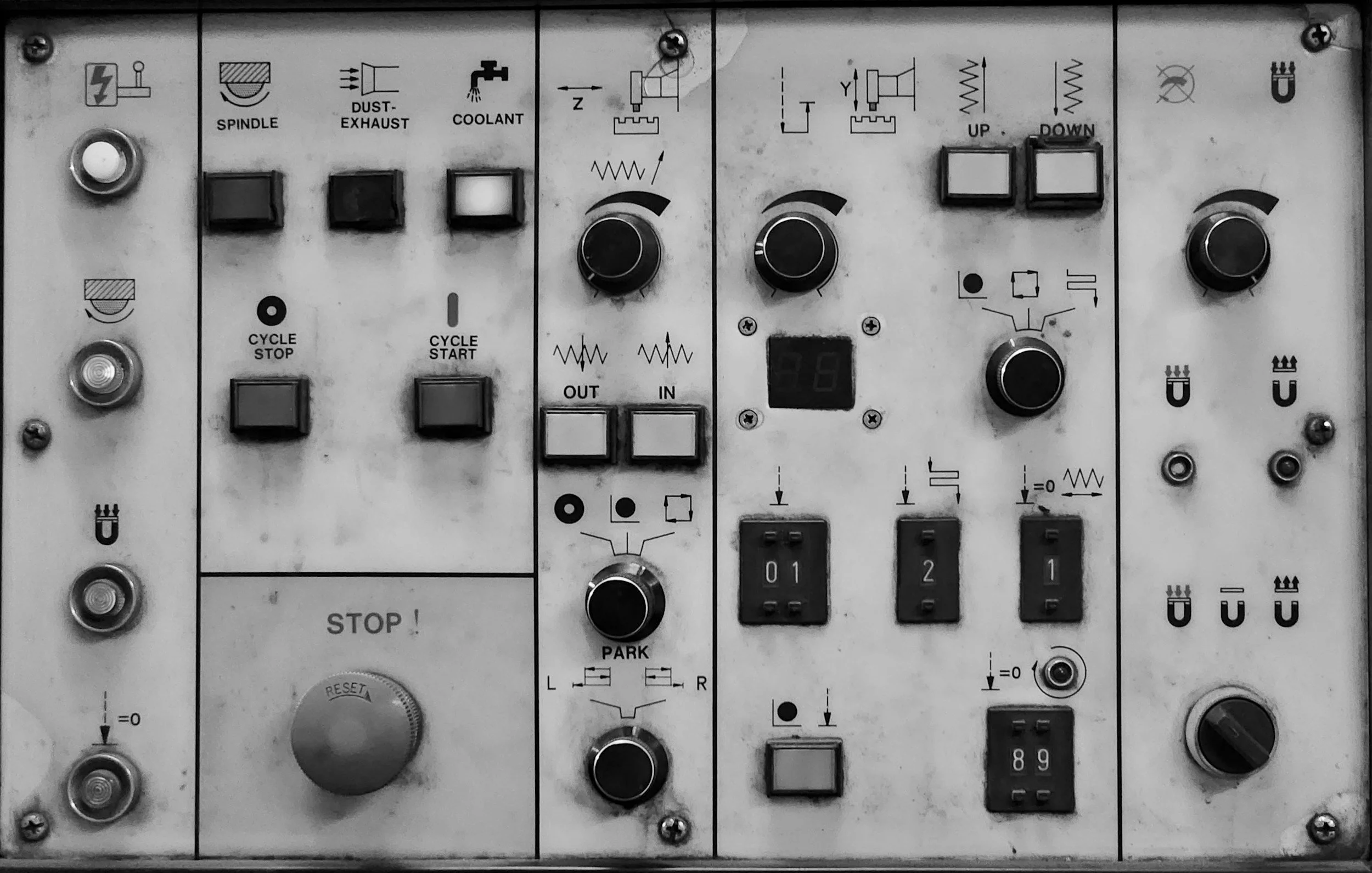 Electrical control panel with switches, dials, and labels for machinery operation.