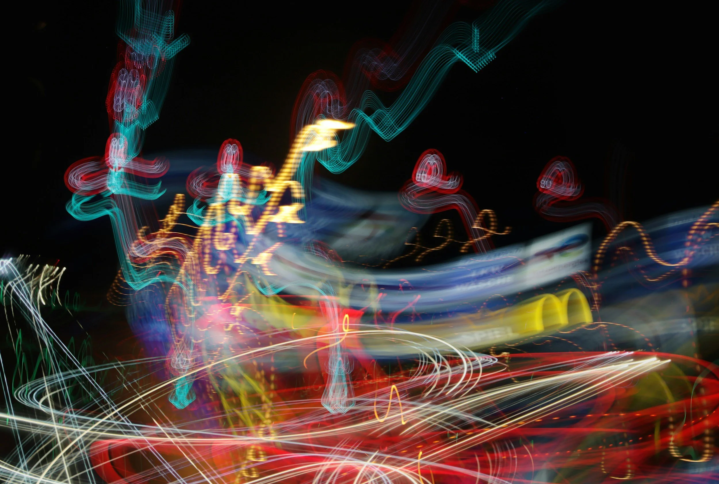 Blurred colorful lights at night creating abstract patterns and demonstrating chaos.