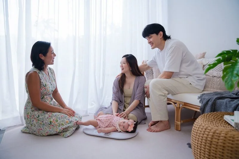 Professional lactation consultant in Singapore providing expert breastfeeding support to a mother and baby.