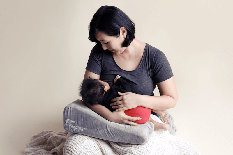 IBCLC certified lactation consultant providing breastfeeding support during a home visit.
