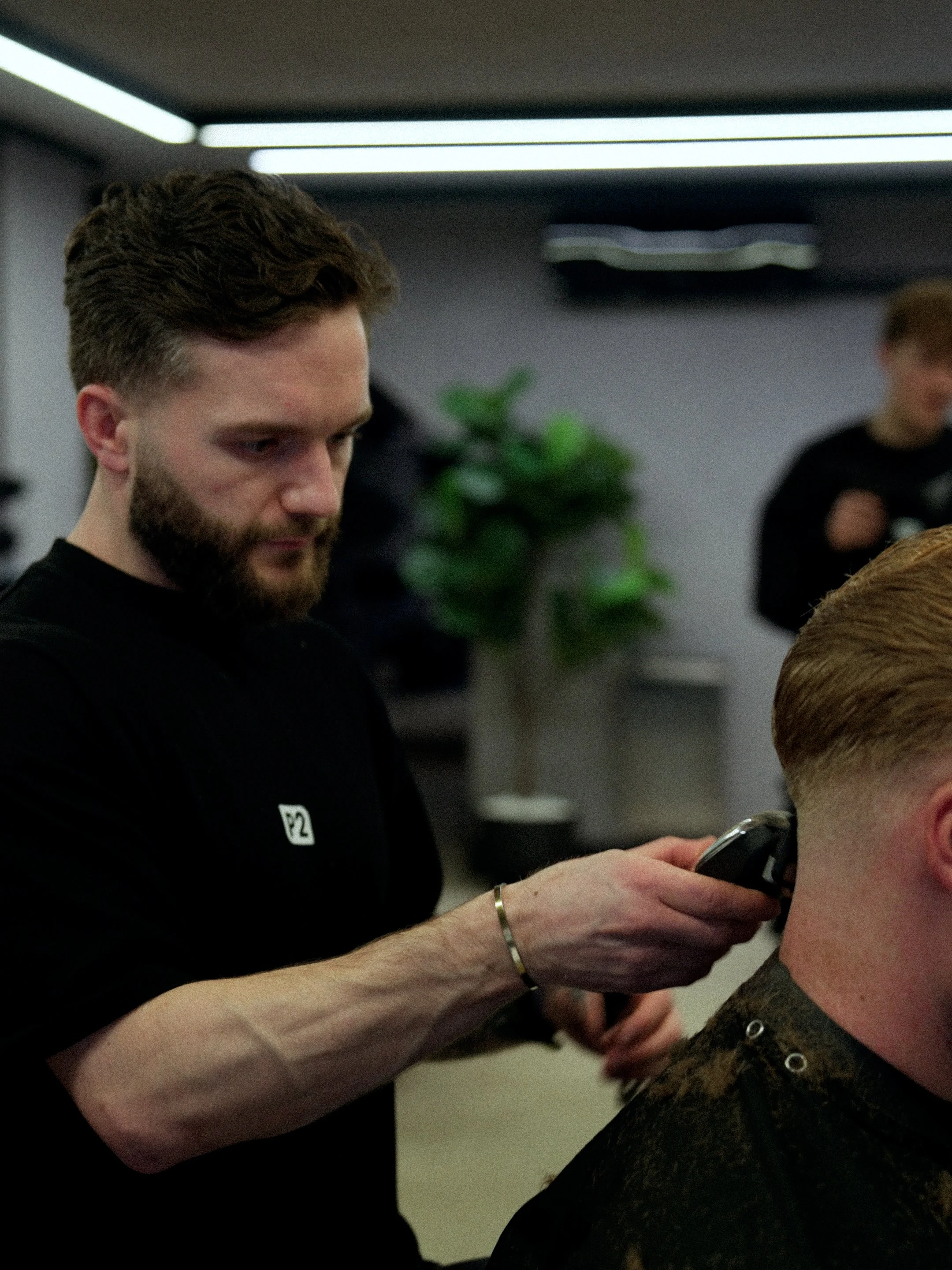 Barber giving a haircut to a customer in a modern barbershop