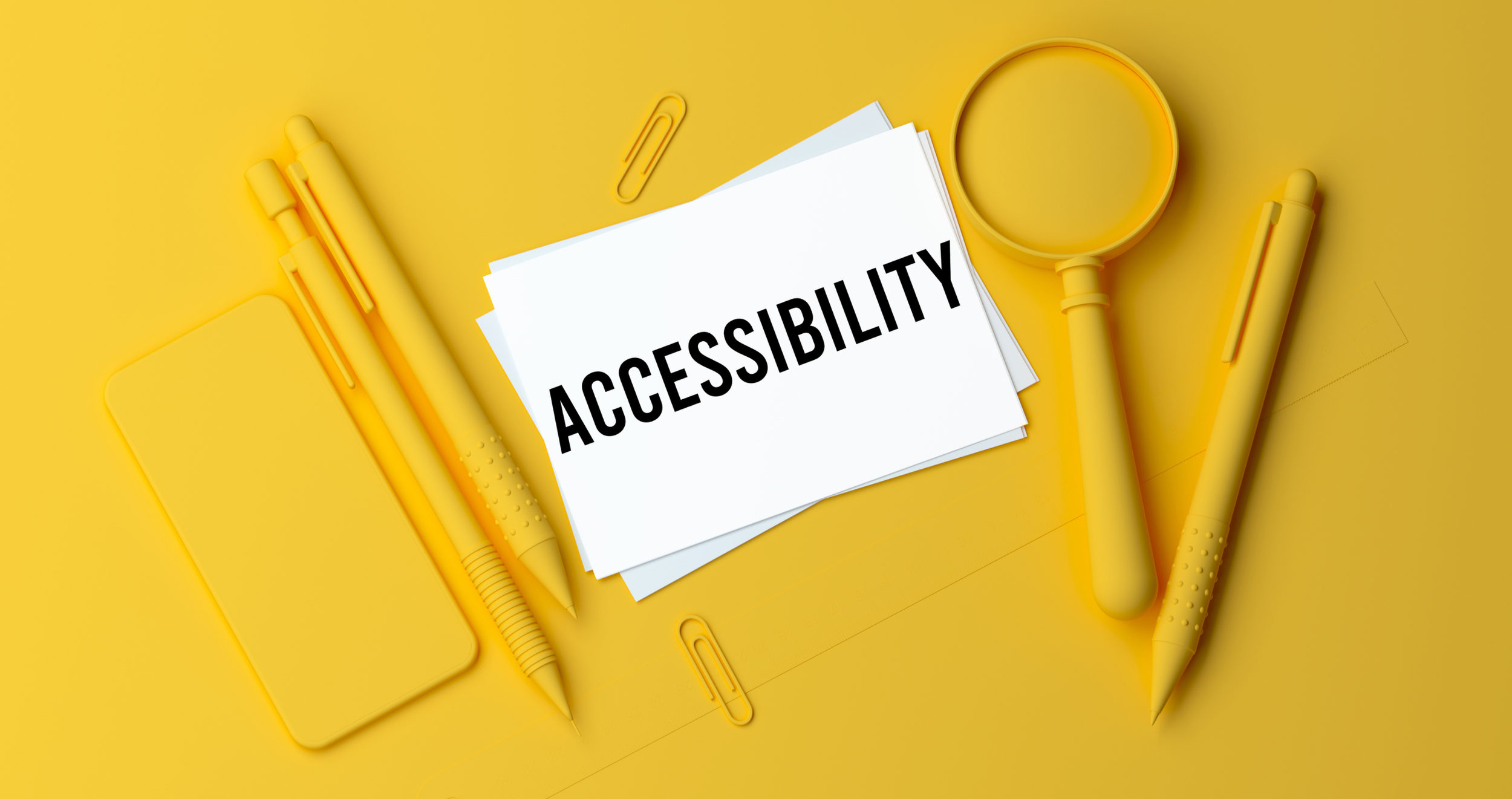 White notecards that read Accessibility on a yellow table with yellow office supplies.