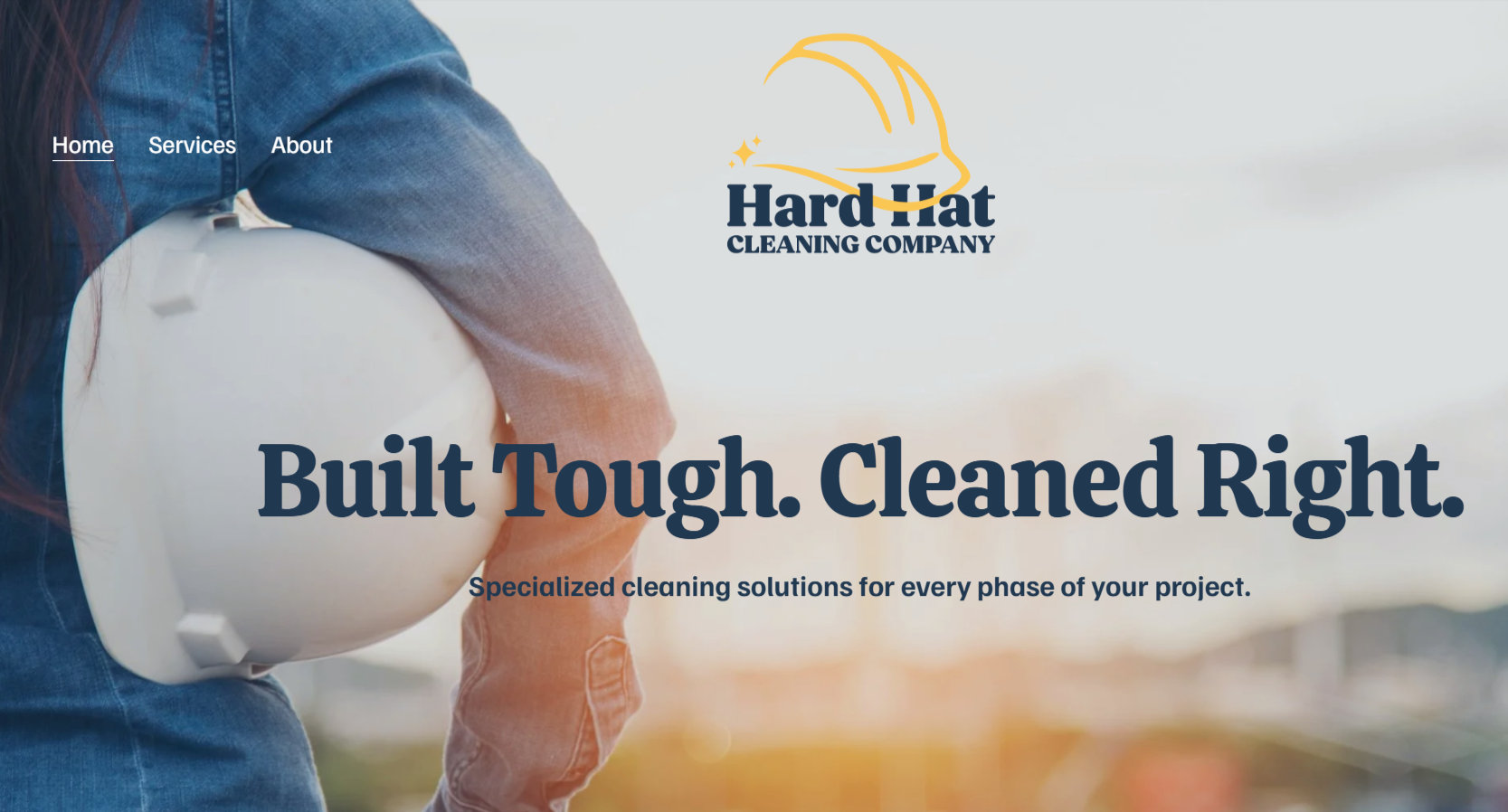 Website homepage for Hard Hat Cleaning Company showing a person holding a white hard hat, with company logo and slogan "Built Tough. Cleaned Right." over a blurred outdoor background.