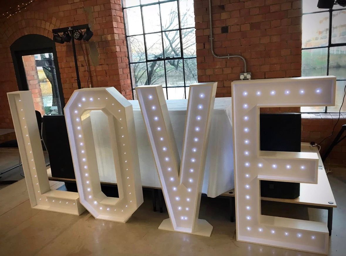 Illuminated LOVE light up letters displayed at an event