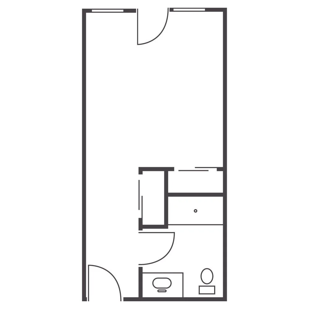 Floor plan of a small apartment with a main entrance, a bathroom with toilet and sink, a small closet or storage space, and a large open living area.