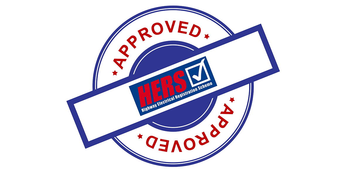 A badge with a circular blue border and the words 'APPROVED' repeated twice in red. Inside, a rectangle with a blue border contains the text 'HERS' in red and 'Highway Electrical Registration Scheme' in white, with a check mark.