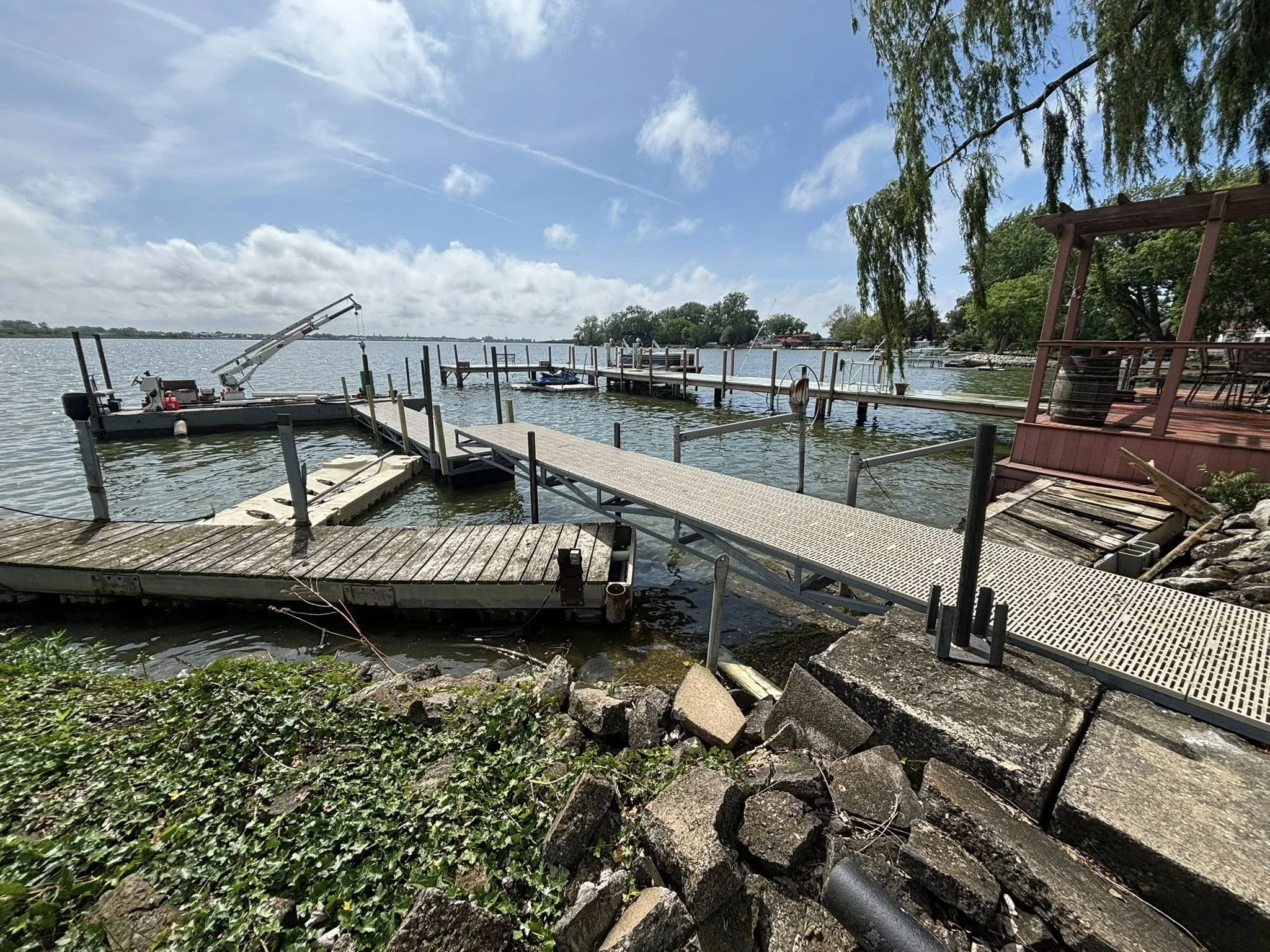 Custom dock being installed in Sandusky Ohio and old dock being removed by Pipe Creek Enterprises 