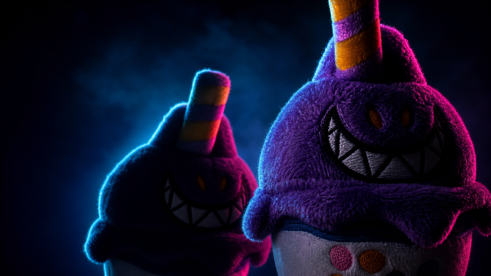 Two plush unicorn toys with purple fur, orange eyes, big embroidered grins with sharp teeth, and rainbow-striped horns, illuminated by vibrant blue and pink lighting.