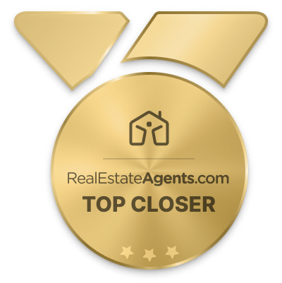 Gold medal award badge with overlapping ribbons, text reading 'RealEstateAgents.com TOP CLOSER' and three stars at the bottom.