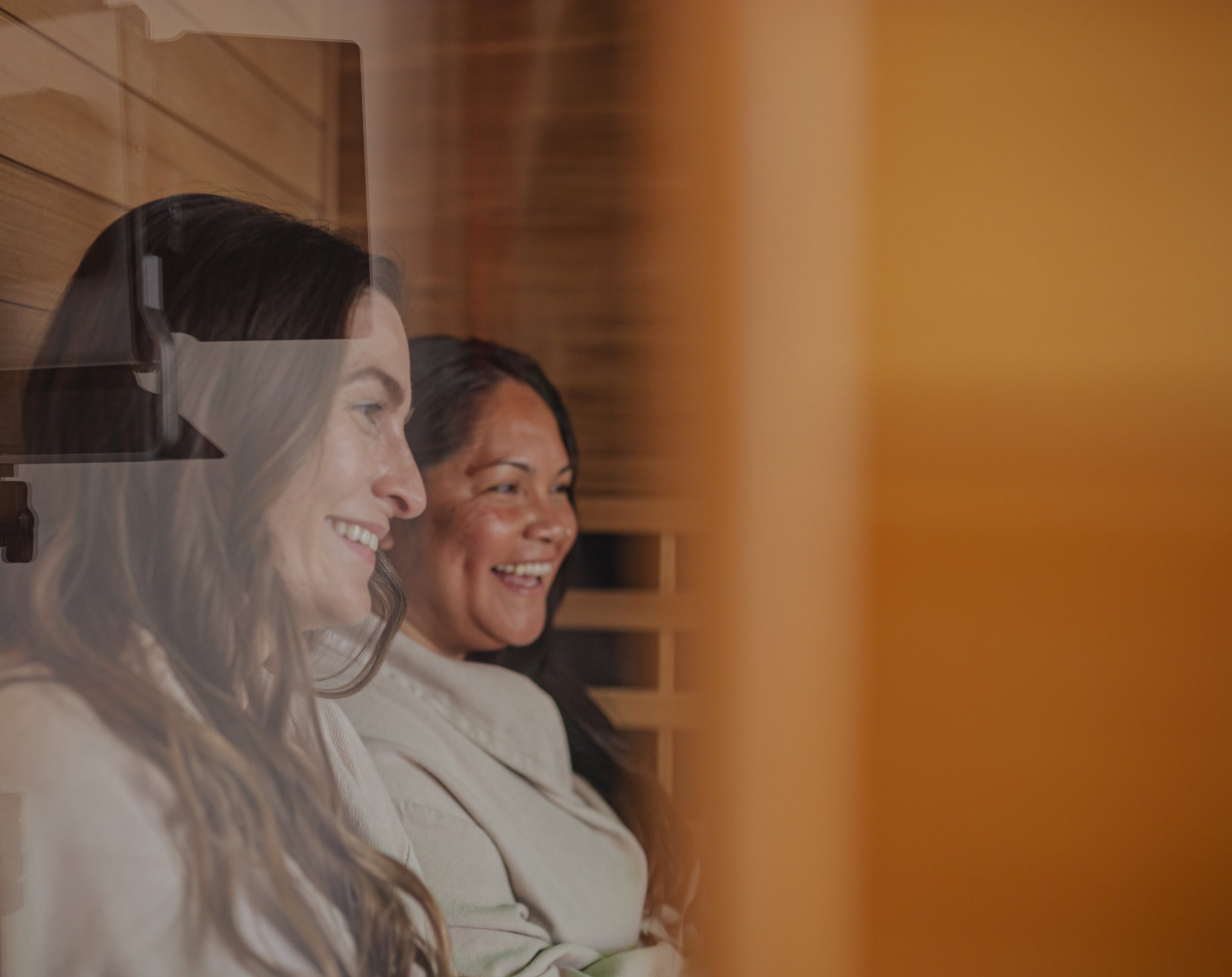 Guests relaxing together inside a spa sauna lounge in Oklahoma City