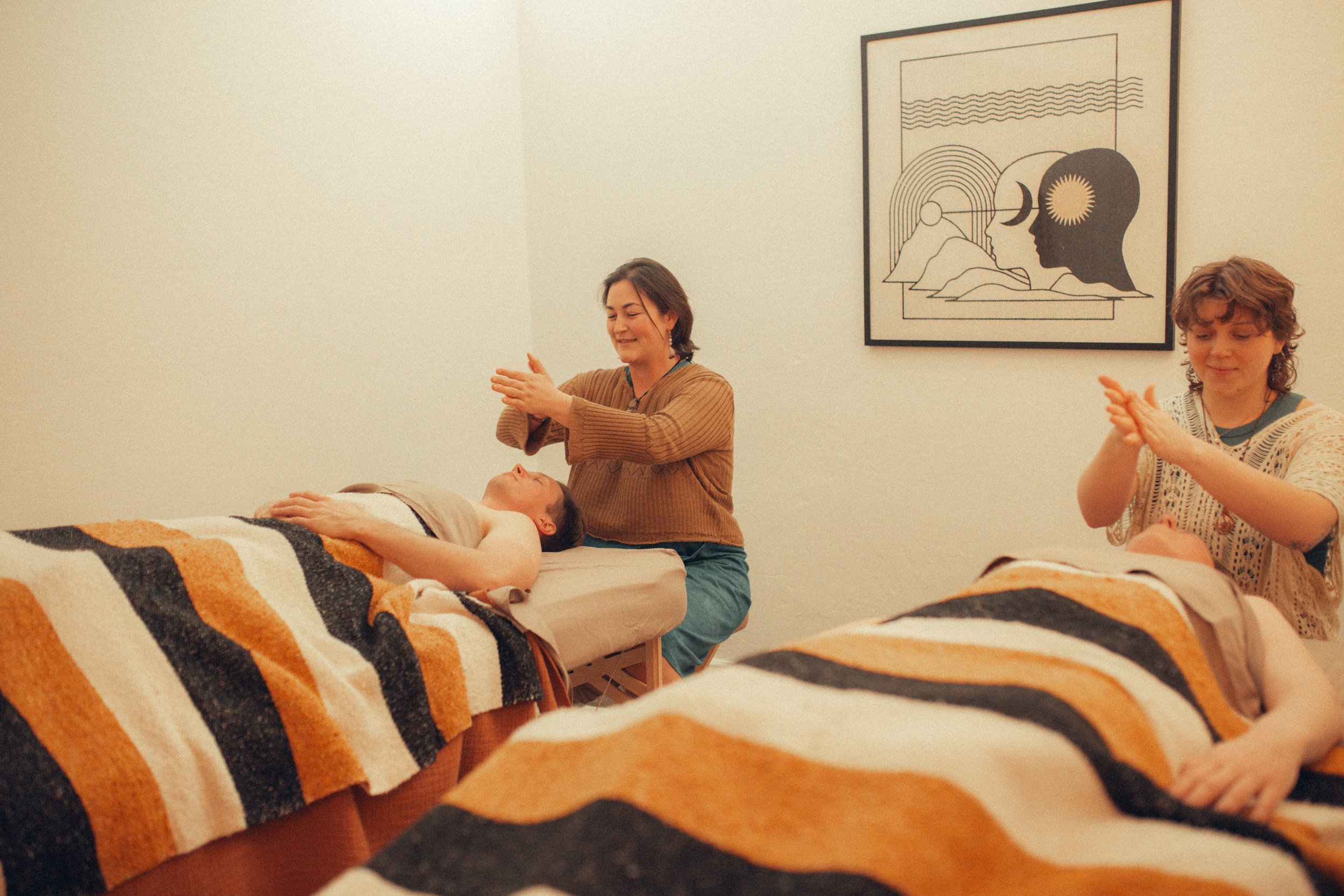 Massage therapists providing hands-on bodywork during a massage session in Oklahoma City