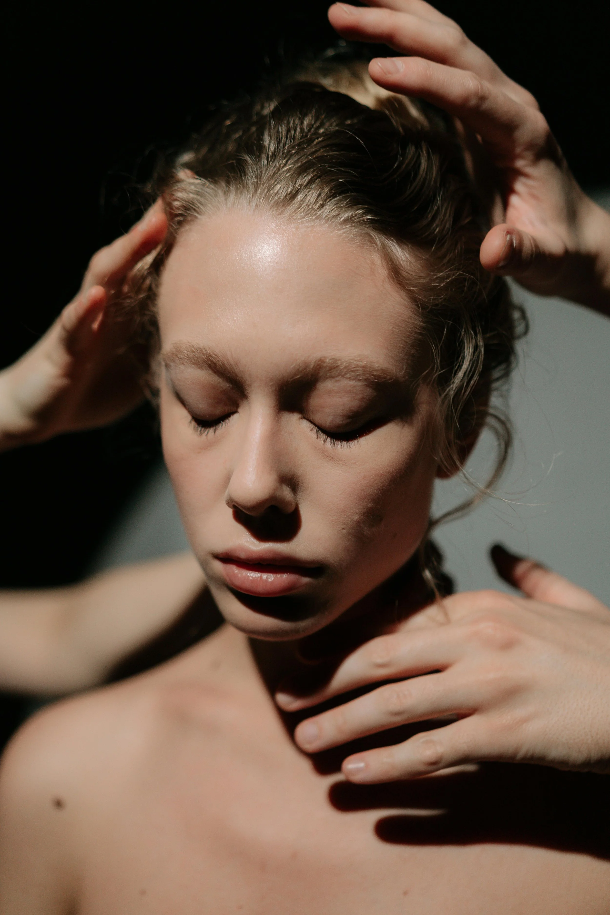 Hands gently hovering around a client’s head during a Reiki energy healing session in Oklahoma City