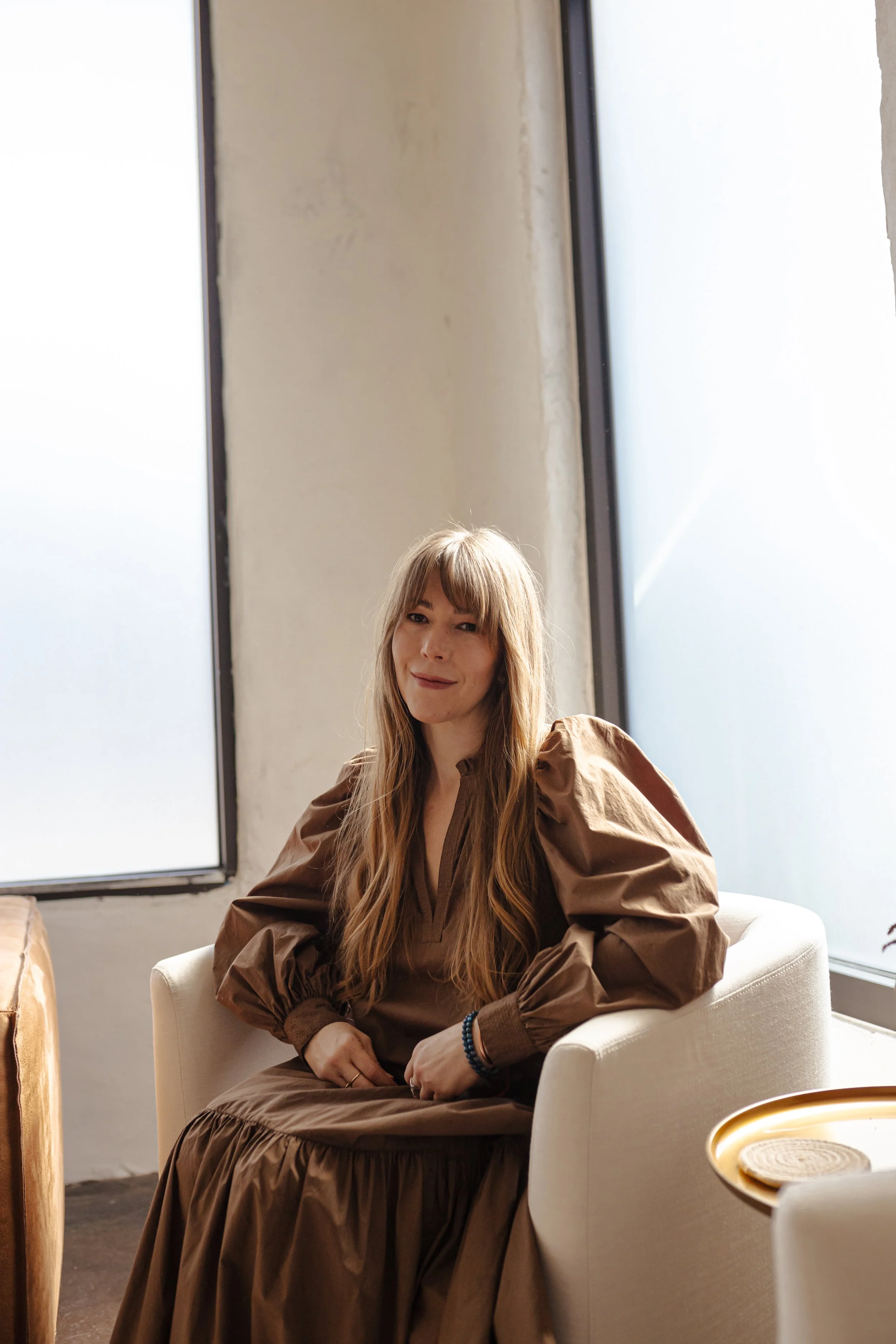 Reiki Master Lisa seated in a calm spa setting in Oklahoma City