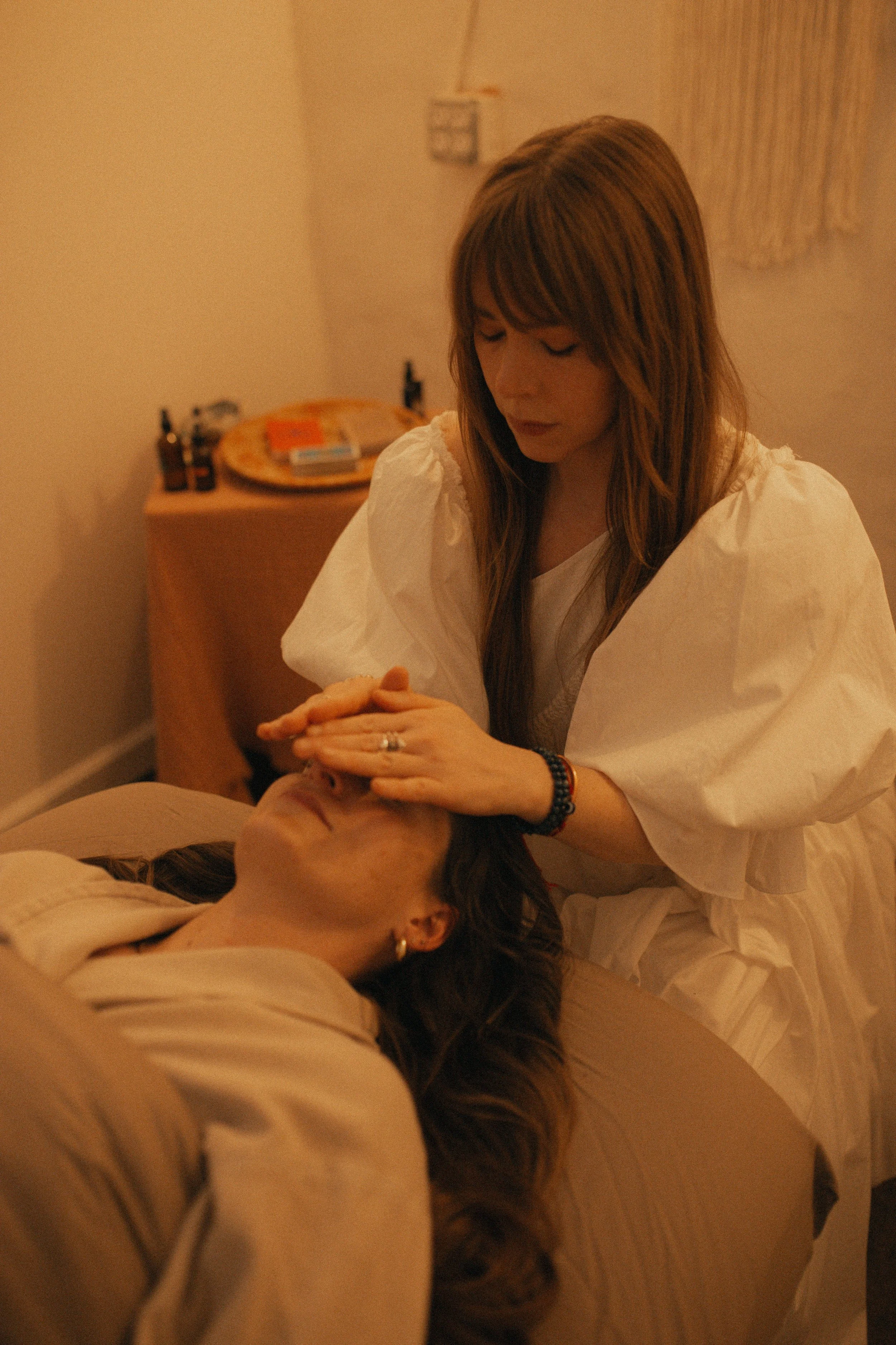 Reiki practitioner providing hands-on energy healing to a client in Oklahoma City