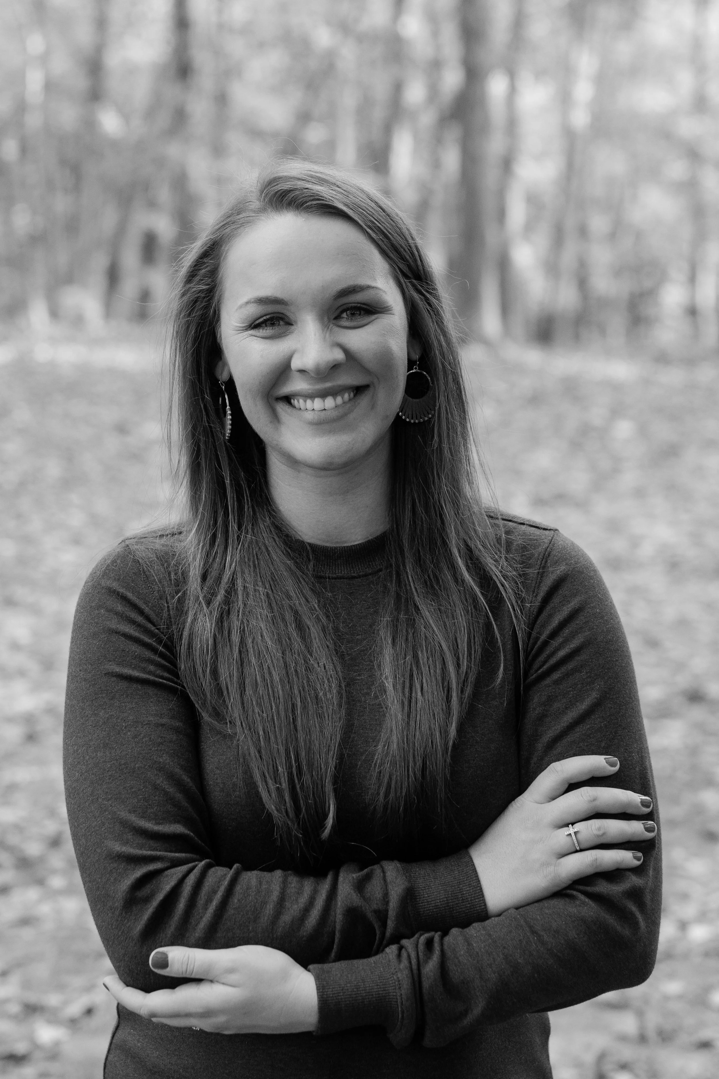 Black and white photo of Lindsay Travis smiling.