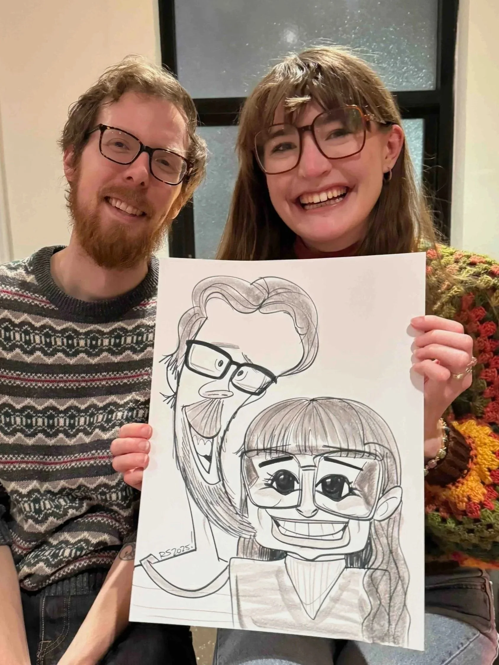 Couple holding a black and white caricature drawing of themselves with exaggerated expressions, drawn live by DRAWING SMILES Caricatures.