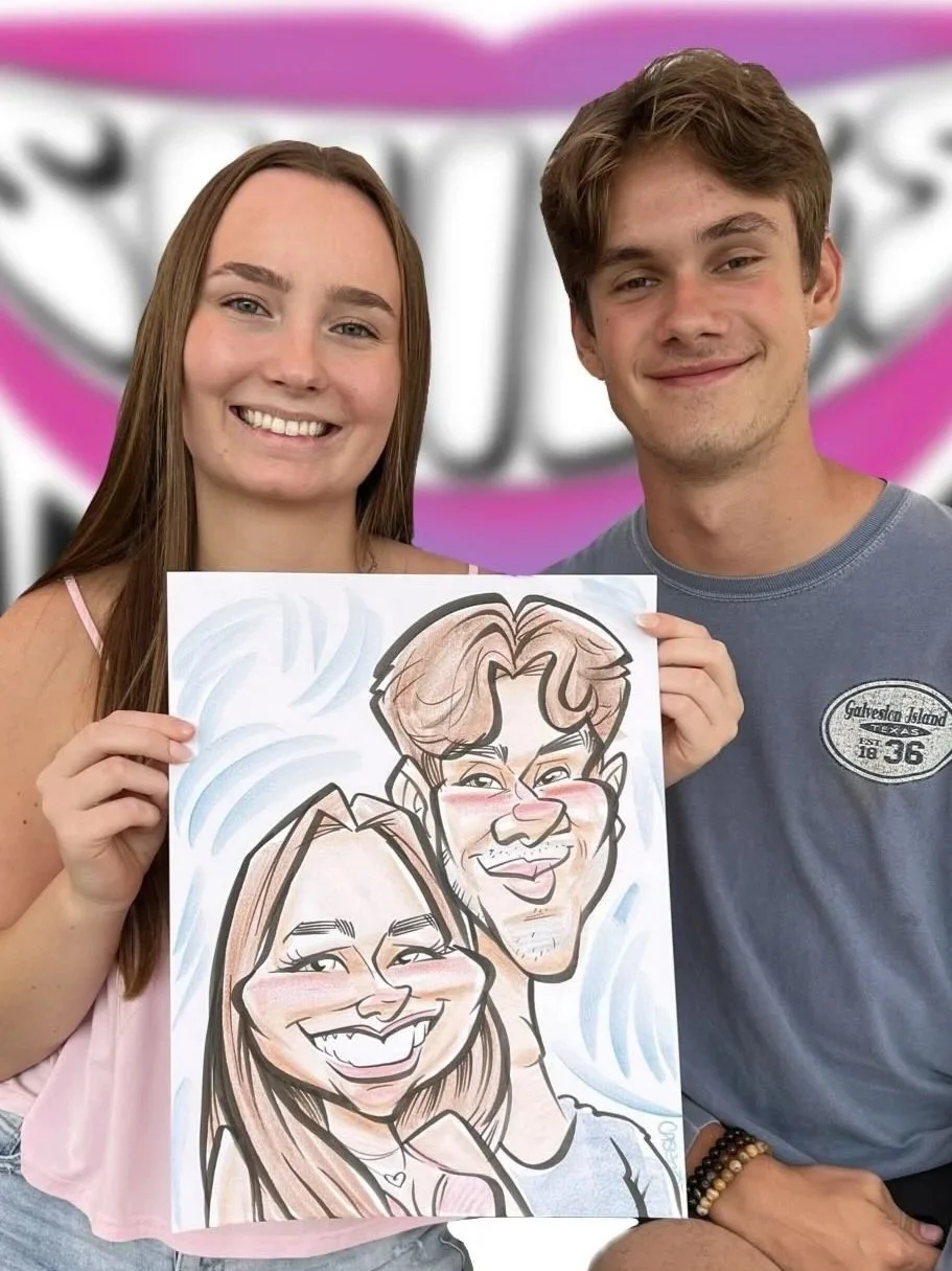 Smiling young woman and man holding their caricature portrait drawn live at a party, with DRAWING SMILES Caricatures banner behind them.