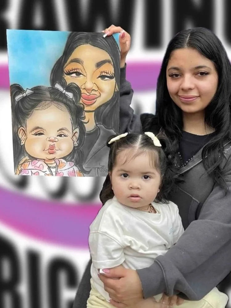 Young woman holding a girl with a caricature drawing of herself and daughter in front of DRAWING SMILES Caricatures logo banner.