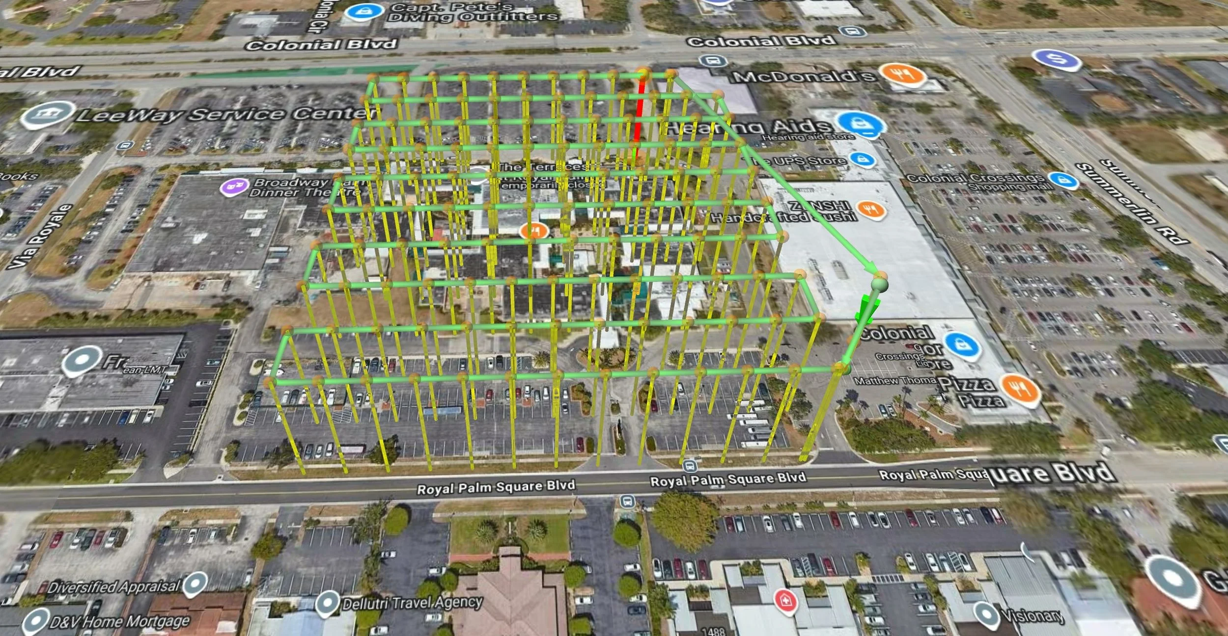3D map view of a commercial area with parking lots and streets, overlaid with a 3D grid of green and yellow lines showing a proposed construction or planning project.
