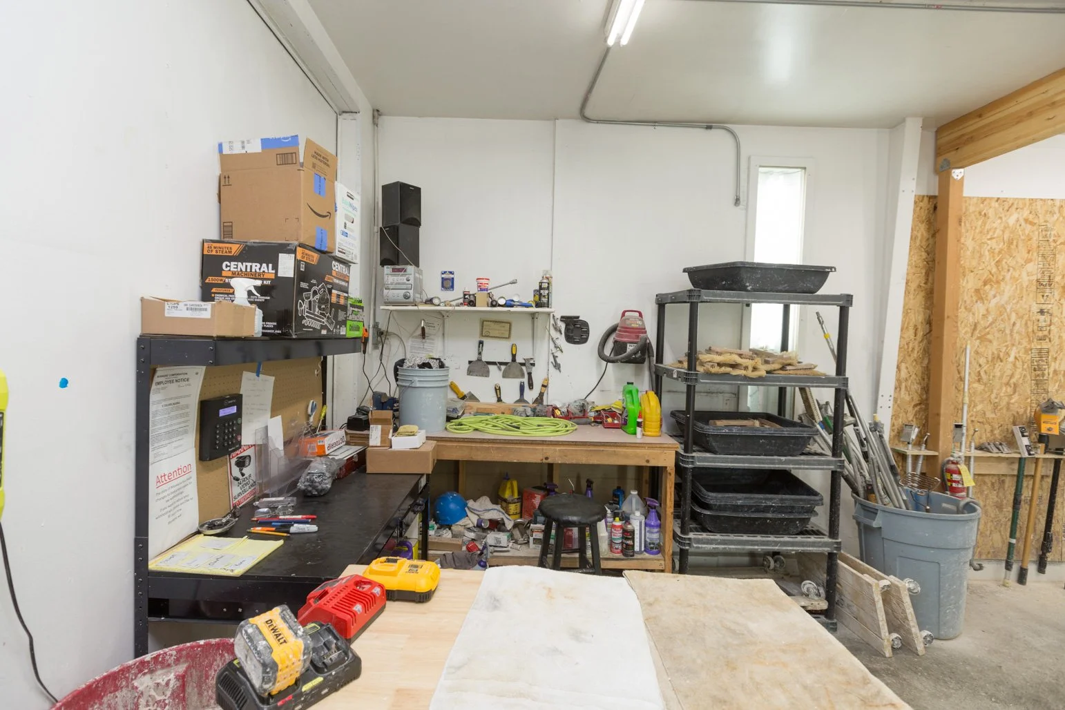 Olbricht workshop with shelves, tools, boxes, and supplies organized on workbenches and storage units.