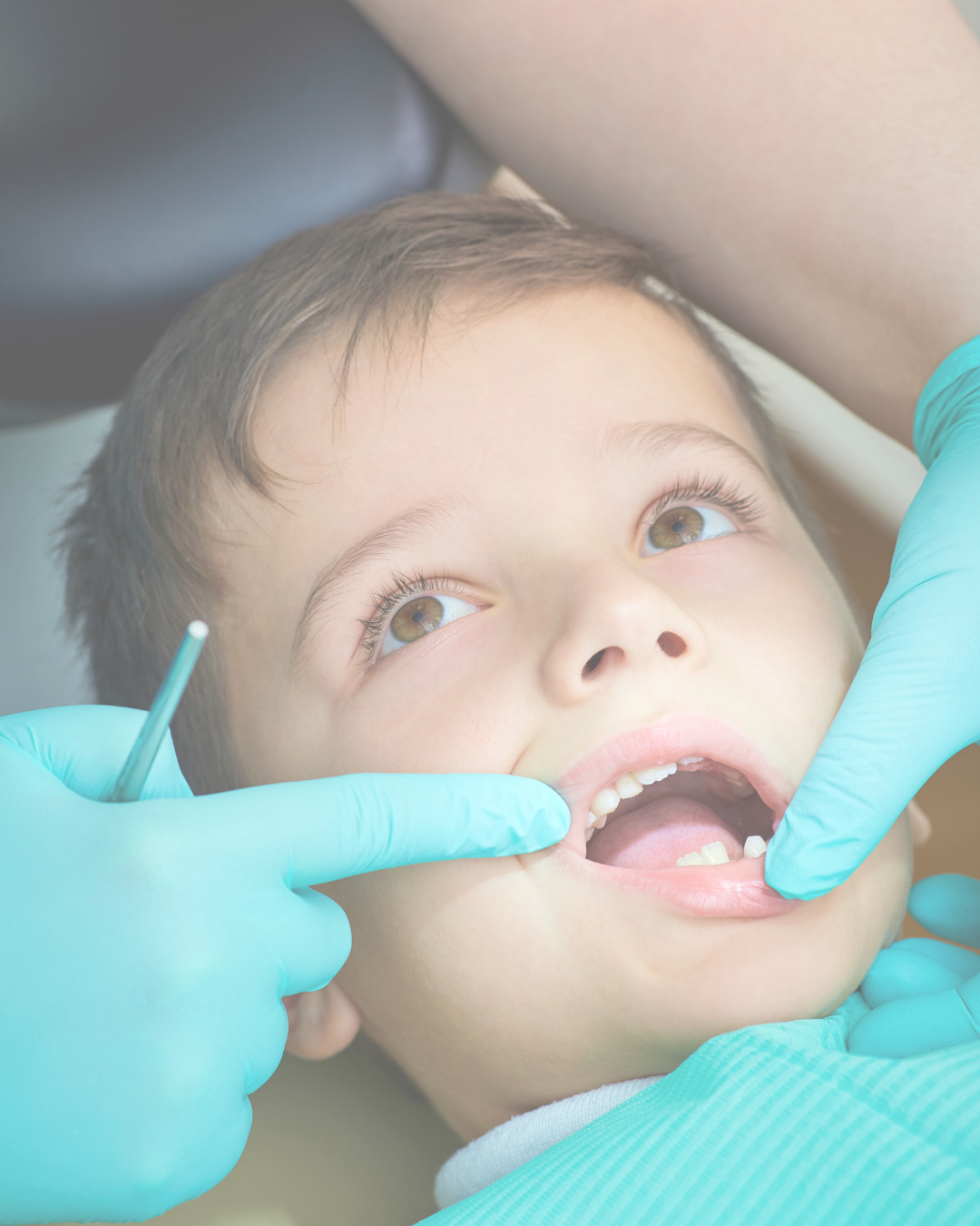Child at the dentist with open mouth, dental tools, and dental gloves.