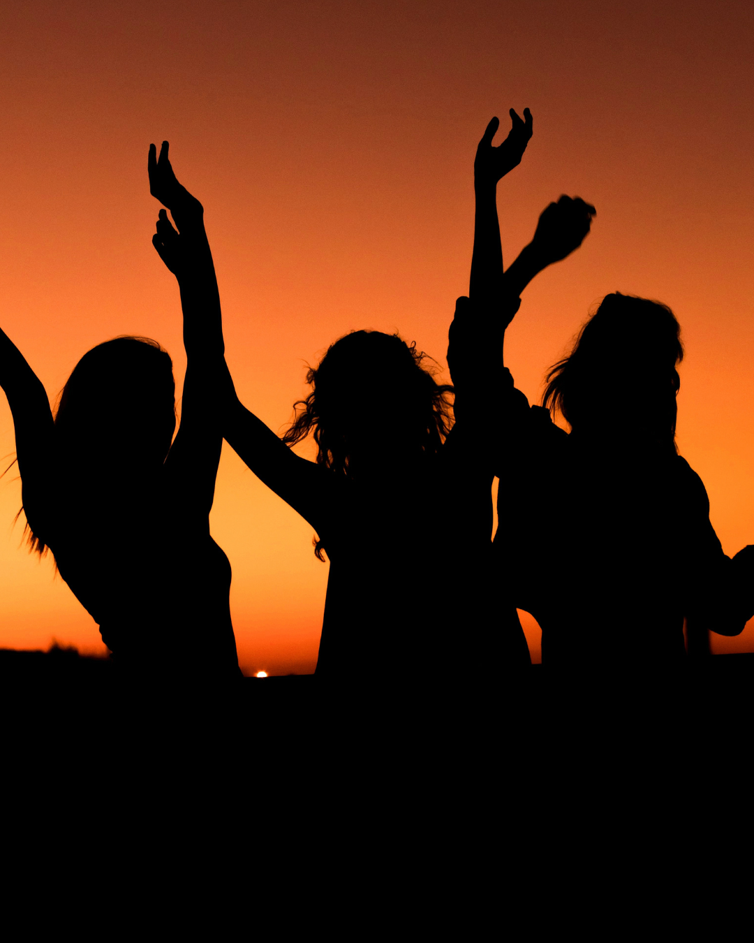 Happy women friends dancing