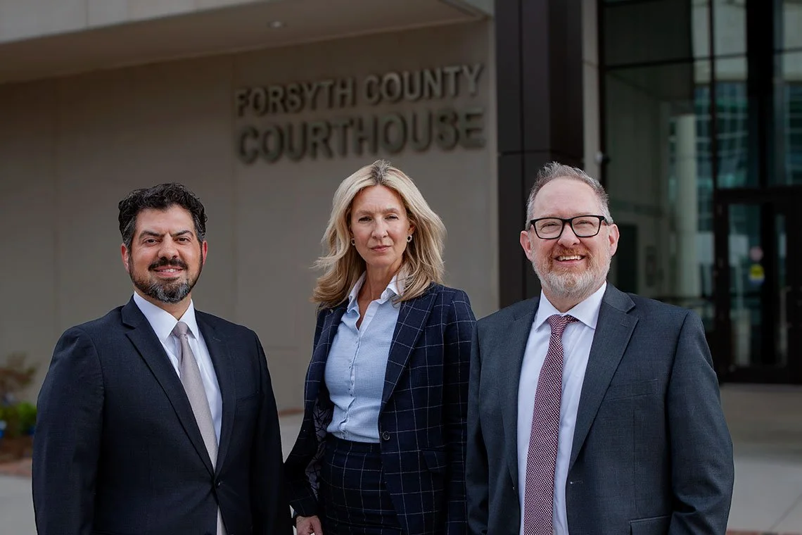 Photo of Craig Principe, Karen Gerber and Graham Green outside the Forsyth County Courthouse