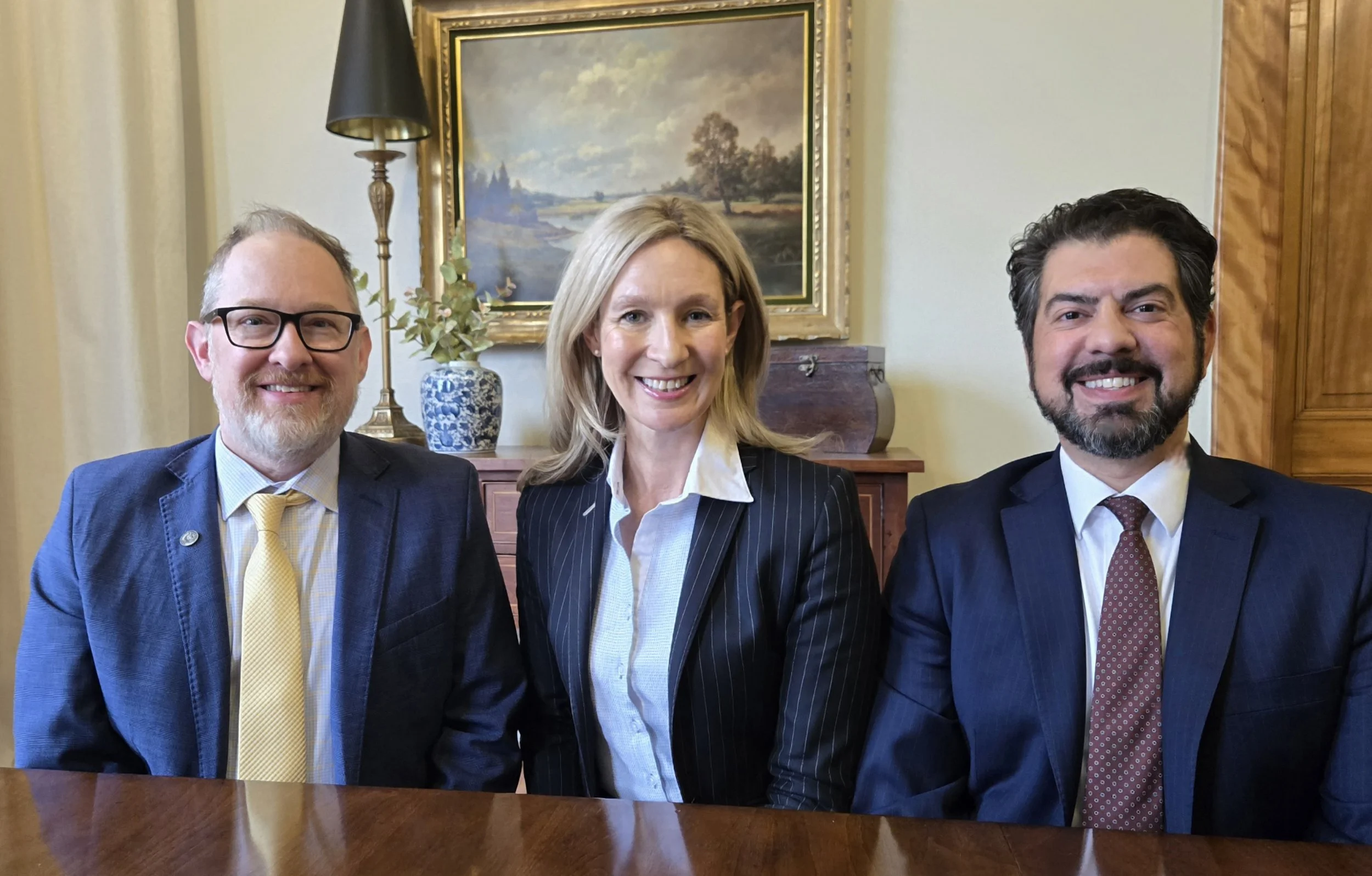 Photo of Graham Green, Karen Gerber and Craig Principe shoulder to shoulder in office