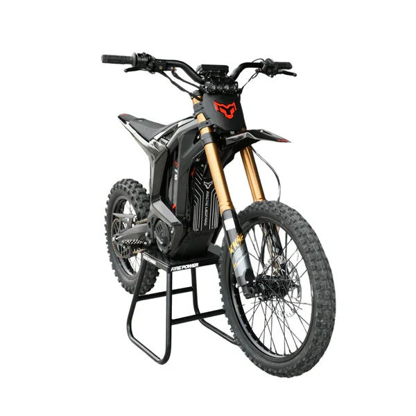 Black and gold electric dirt bike with knobby tires, displayed on a stand against a white background.