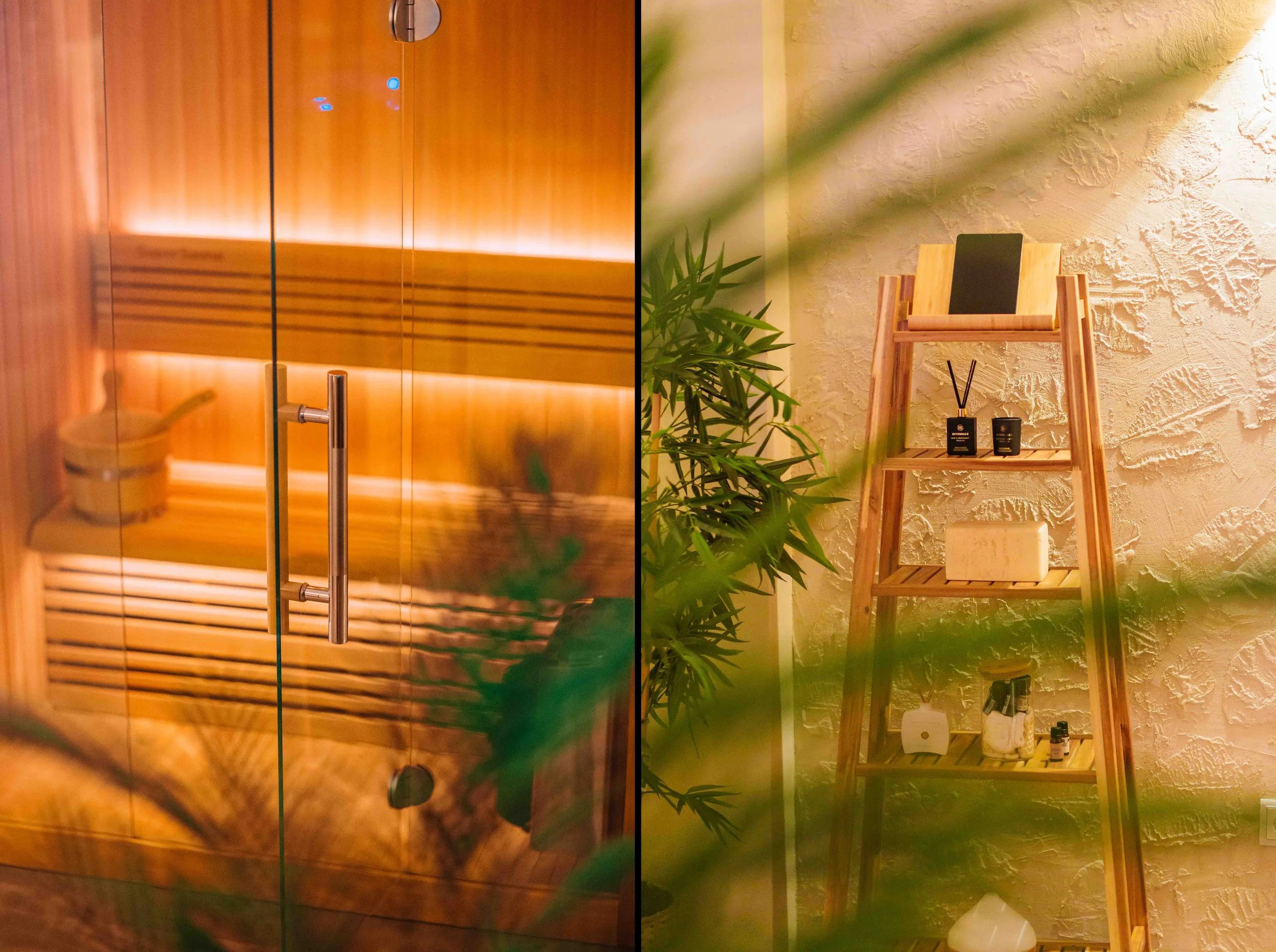 A wooden door with a handle, and a wooden ladder shelf decorated with small black containers, a soap bar, and a framed picture, with green plants in the foreground and a textured white wall in the background.