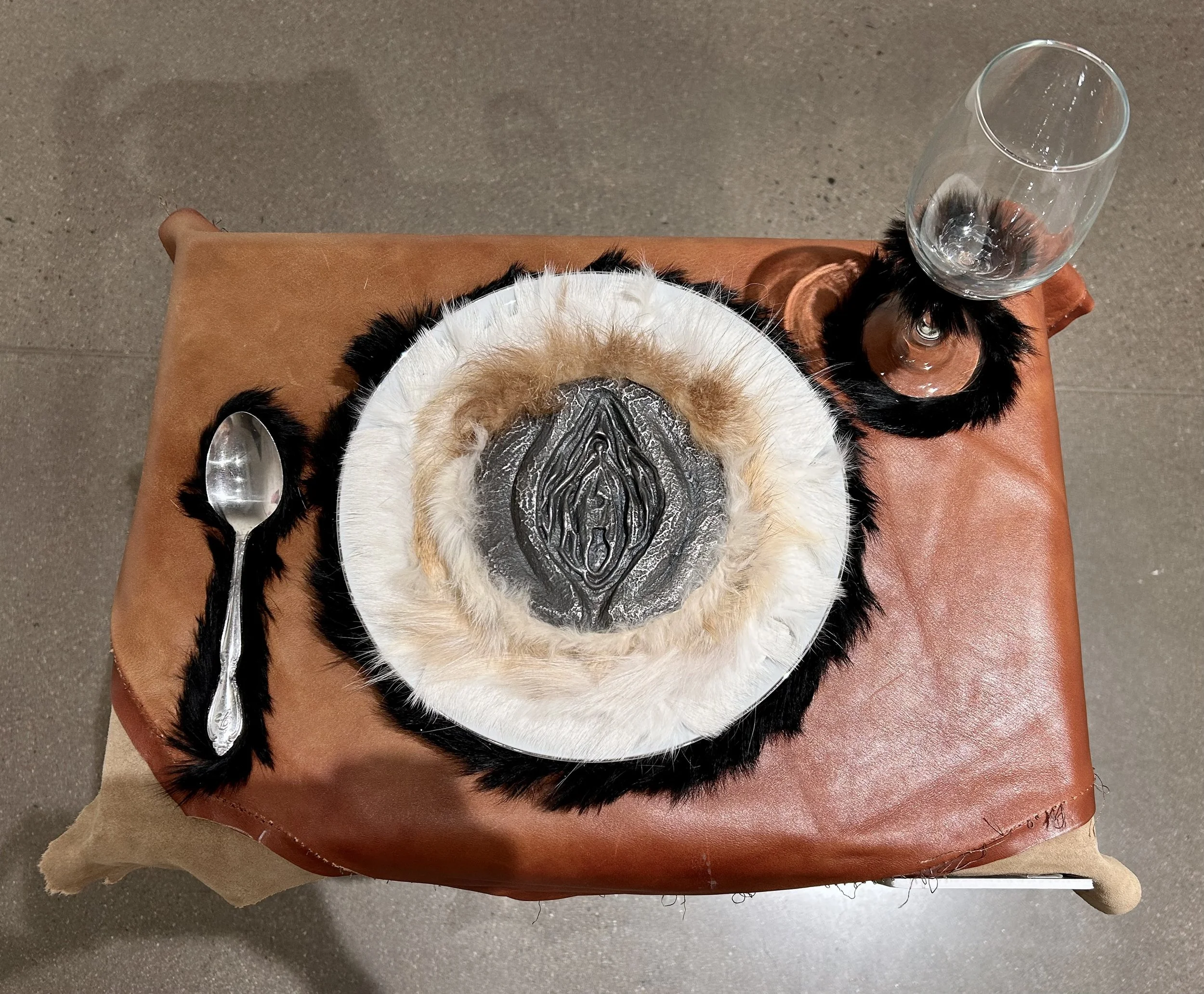 "Dinner" cast iron, rabbit fur, calf fur, raccoon fur, coyote fur, leather, wine glass, spoon, plate, 2025