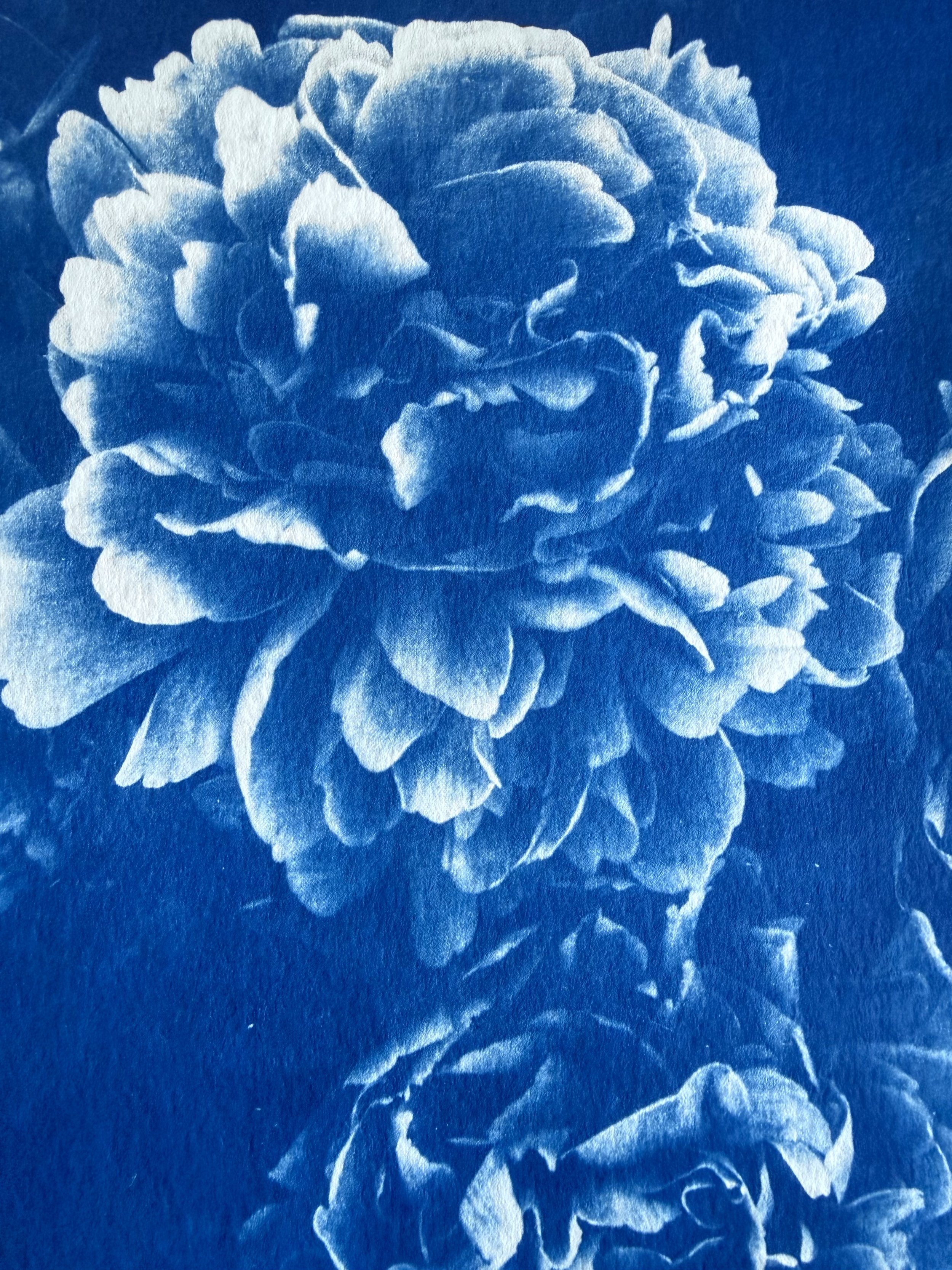 Close-up of a floral pattern featuring a large peony with detailed petals, rendered in a monochromatic blue and white watercolor style.