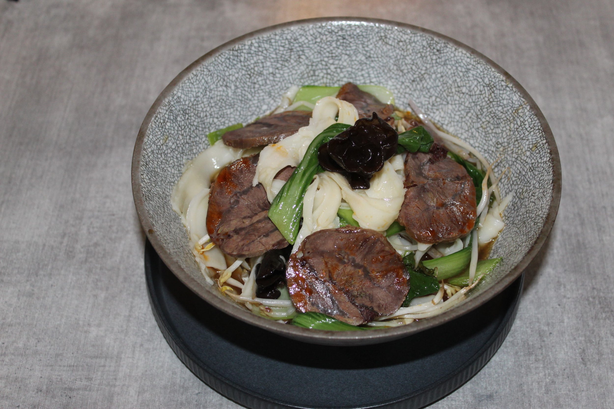 Bowl of Asian stir-fry with beef, vegetables, and black fungus mushrooms.