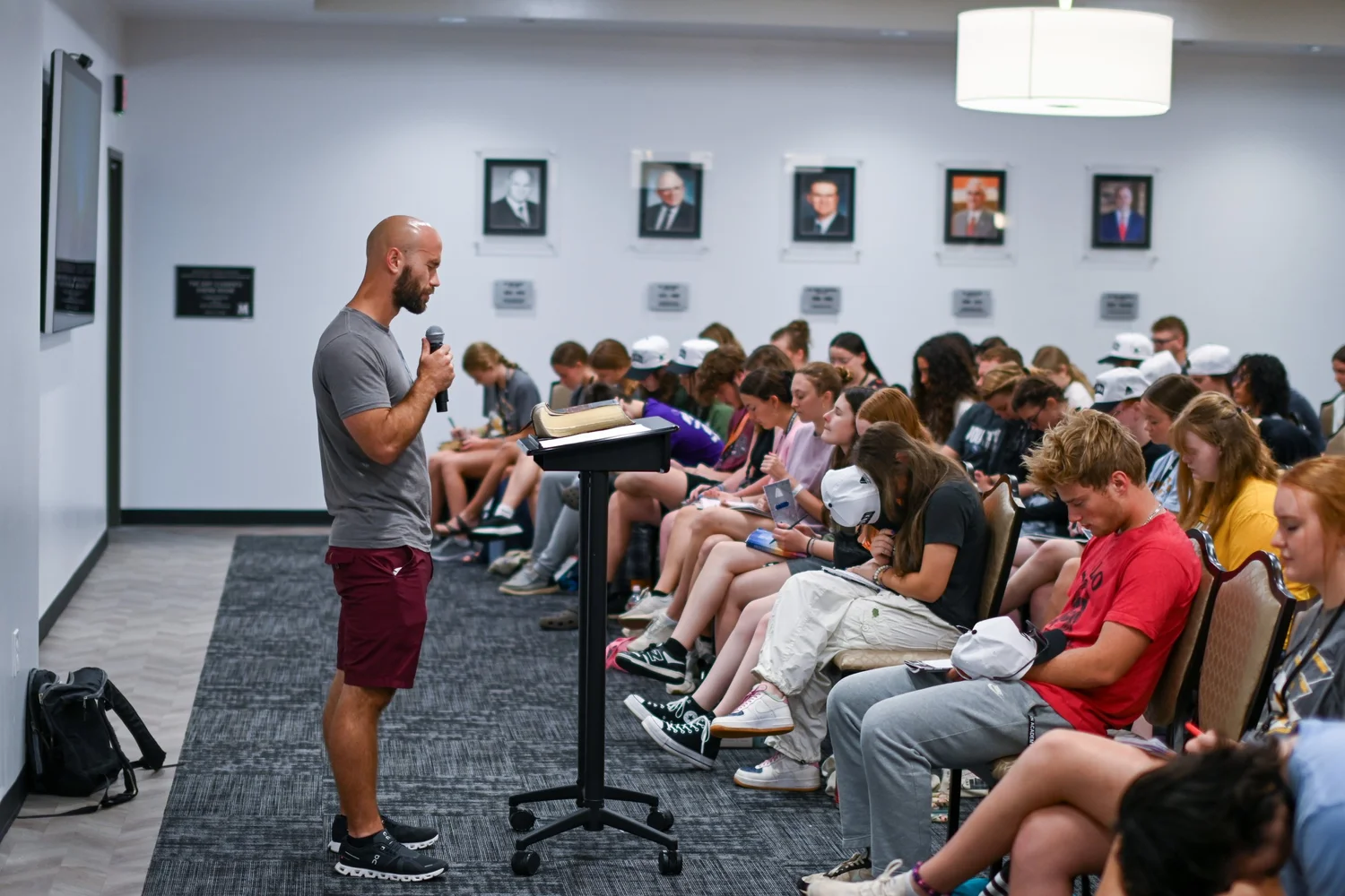 A leader teaching a room of interns