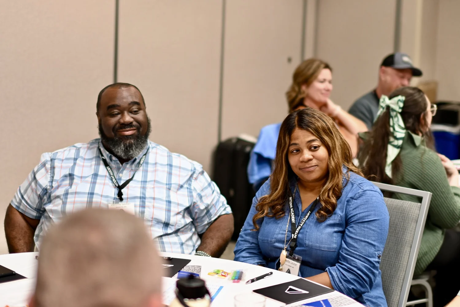 Coaches gathered around a table at an Intern Academy training