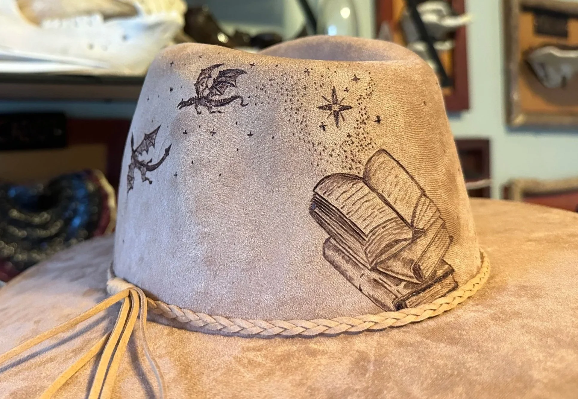 vegan suede rancher fedora with a book opening and stars and dragon flying out.