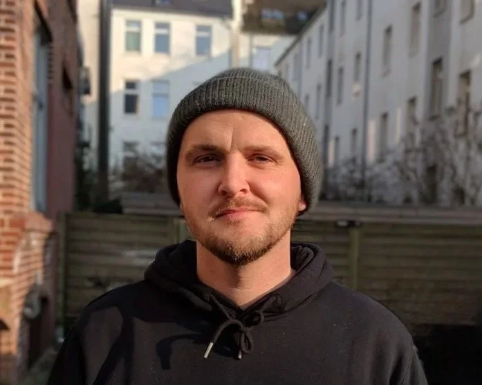 Portrait of Andreas Gröger, Creative Director, photographed outdoors in natural light.